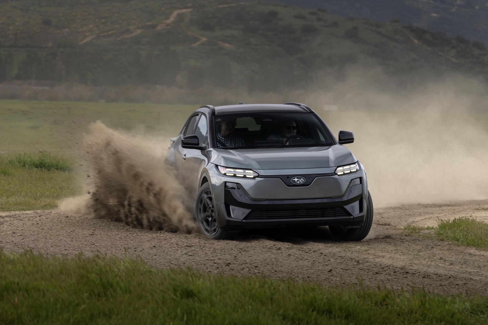 2026 Subaru Uncharted electric SUV in grey kicking up dust on a dirt surface