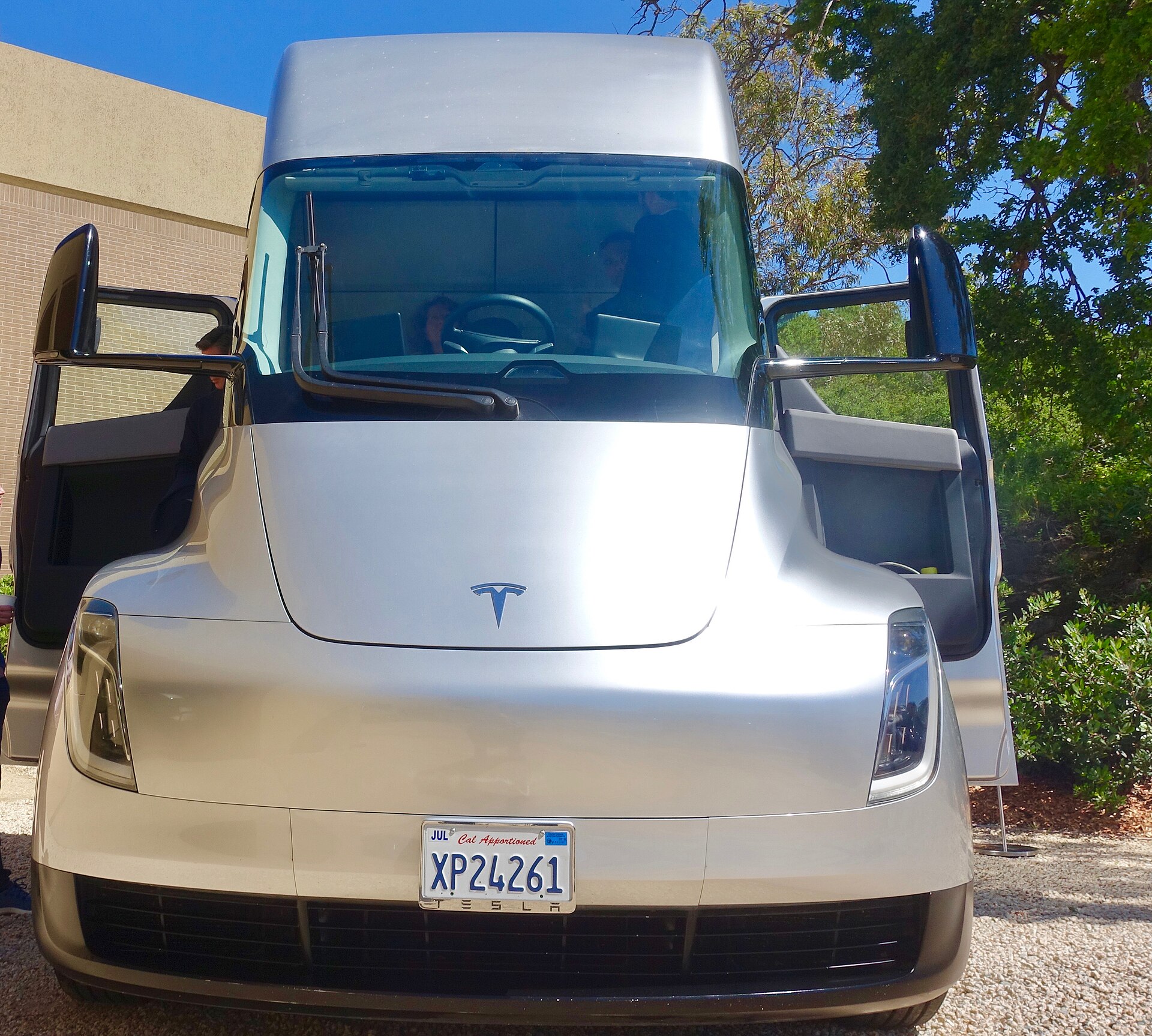 Front view of a silver Tesla Semi prototype with both cab doors open