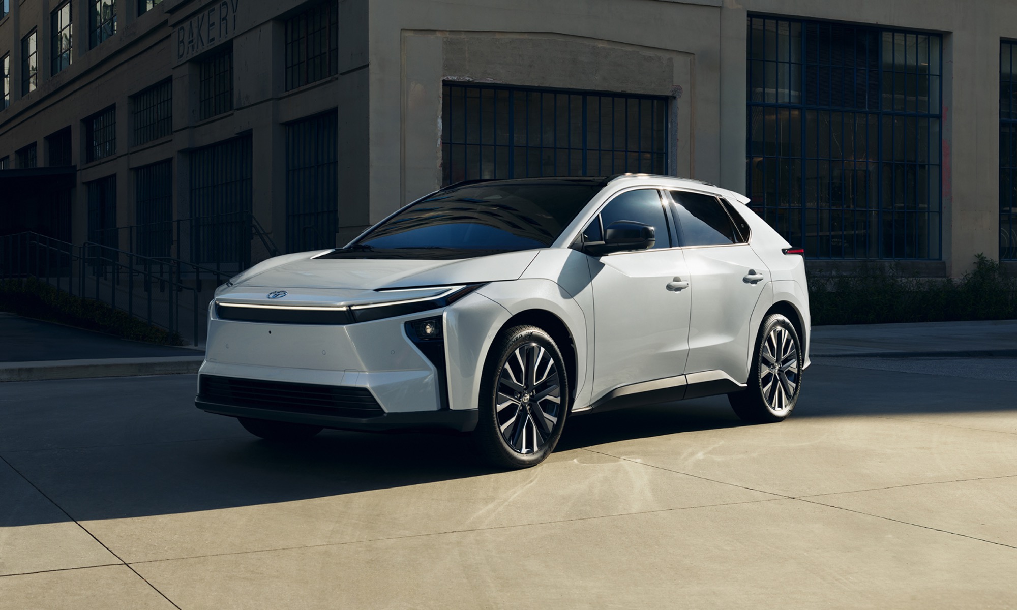 2026 Toyota bZ electric SUV in white, front three-quarter view in an urban setting
