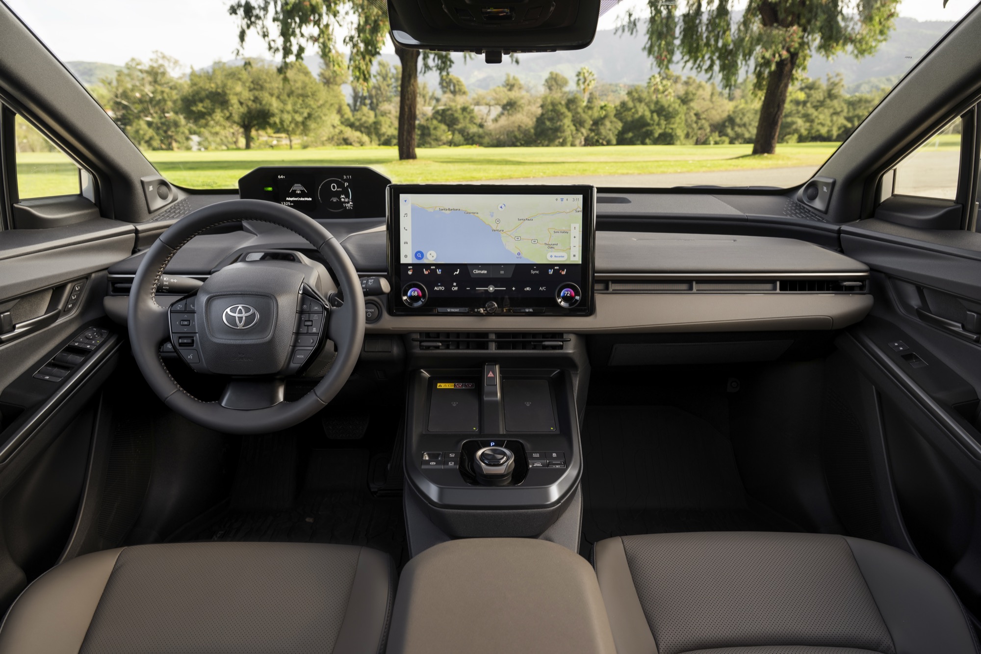 Interior of the 2026 Toyota bZ Woodland in Stone Brown, showing the dashboard and 14-inch screen
