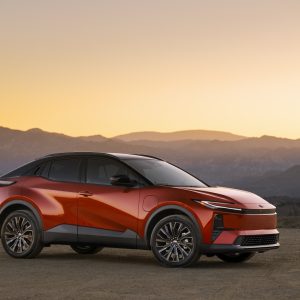 2026 Toyota C-HR BEV in red, side profile at sunset with mountains behind