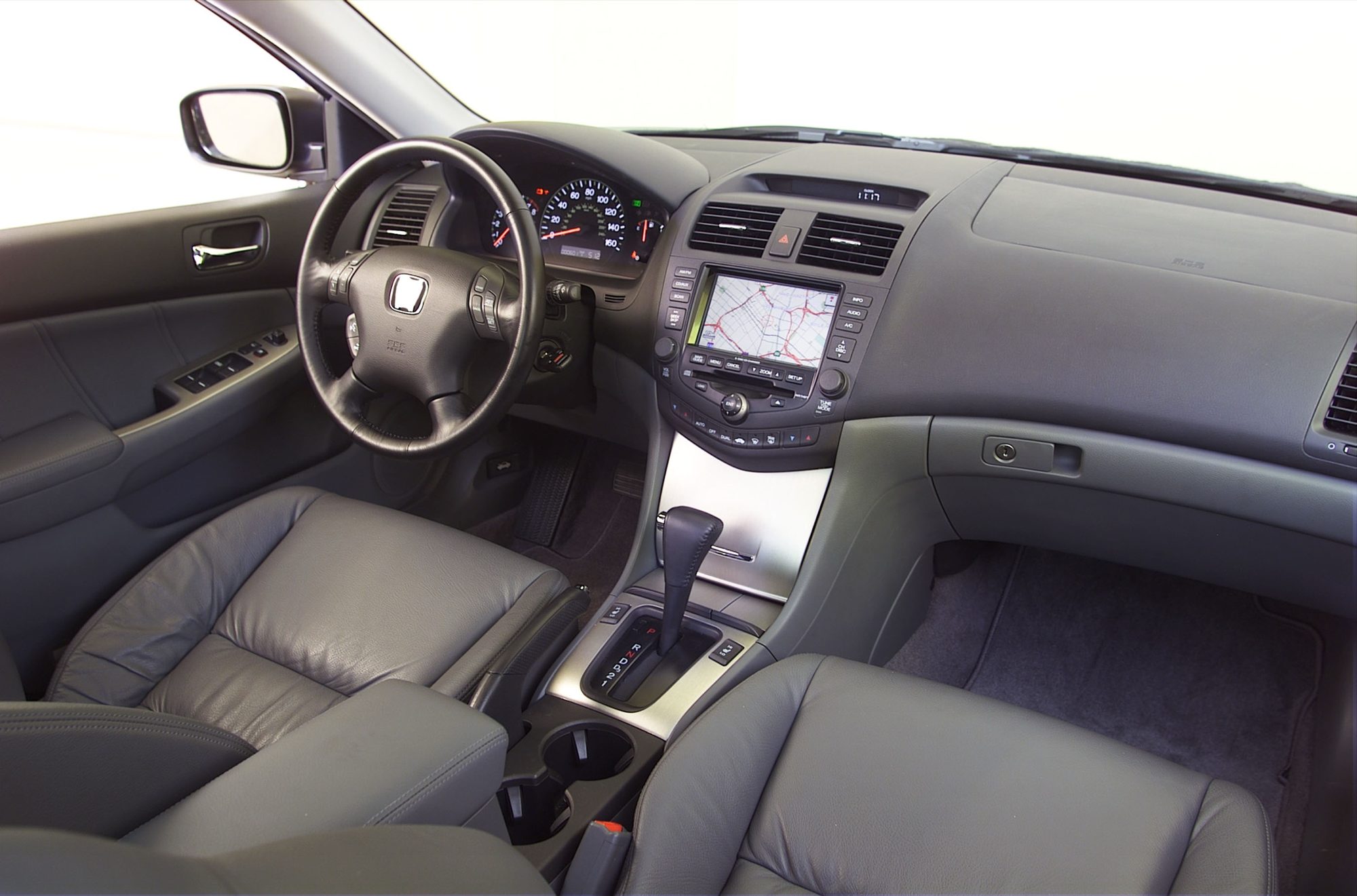 Dashboard and gray leather front seats of a 2004 Honda Accord