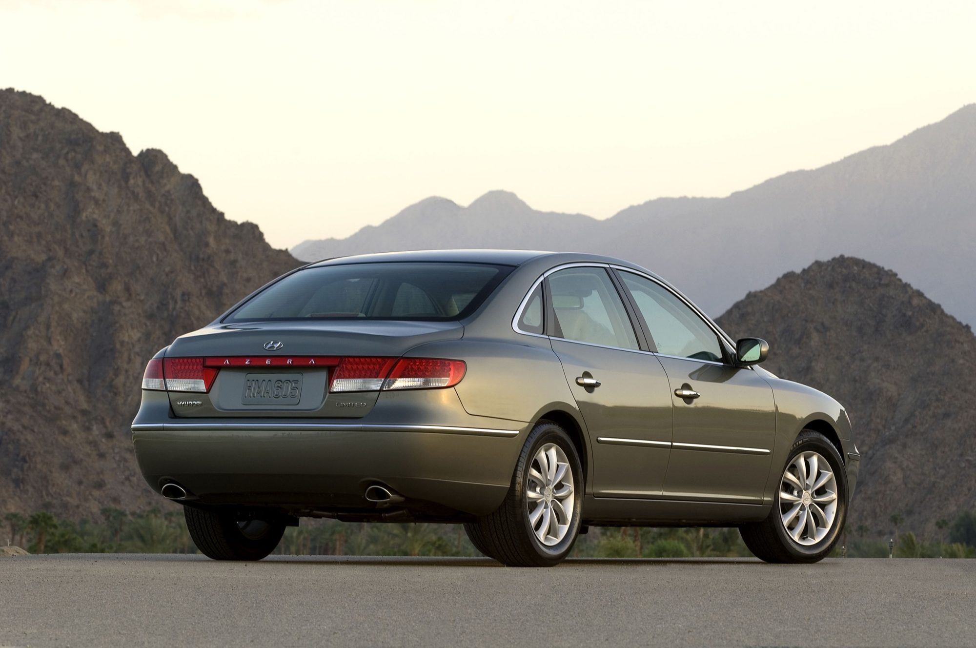 Rear three-quarter view of a gray-green 2006 Hyundai Azera Limited showing its Limited badge