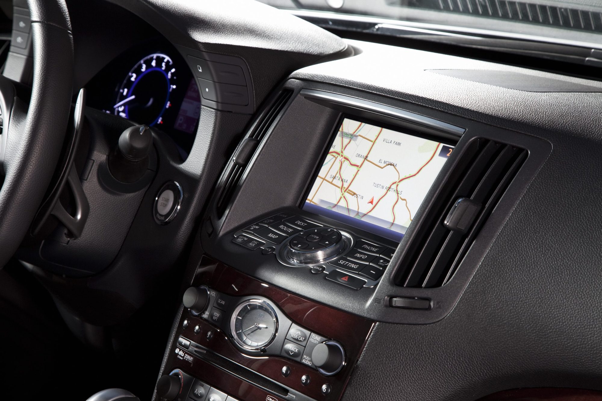 Navigation screen, controller and wood-trimmed audio panel in the 2011 Infiniti G37 sedan