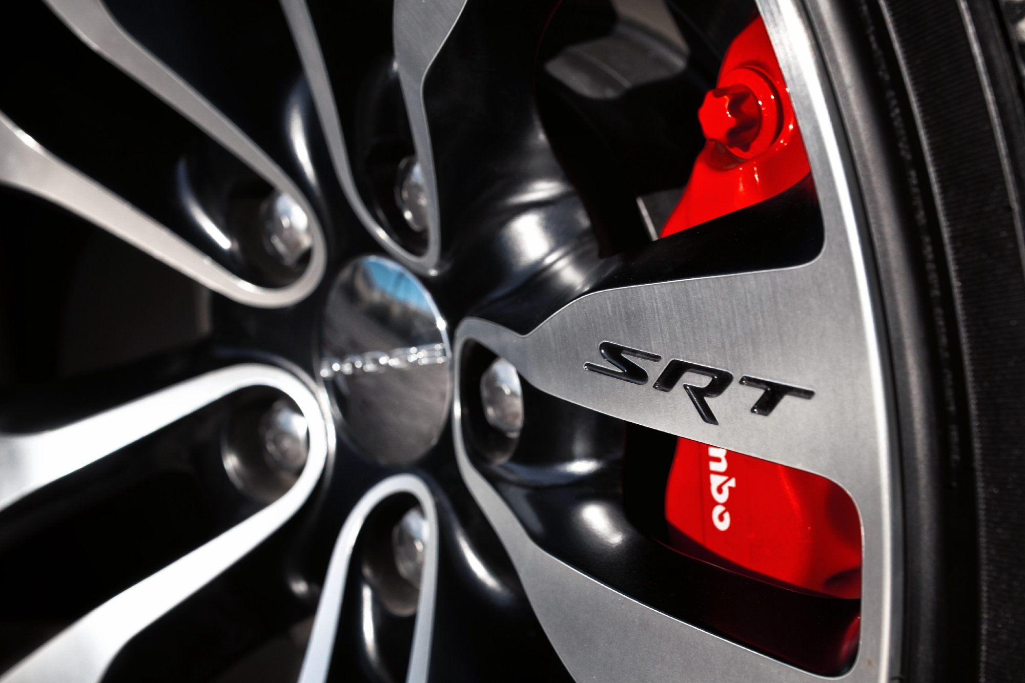 SRT-design 20-inch wheel and red four-piston Brembo brake caliper on the 2012 Dodge Charger SRT8