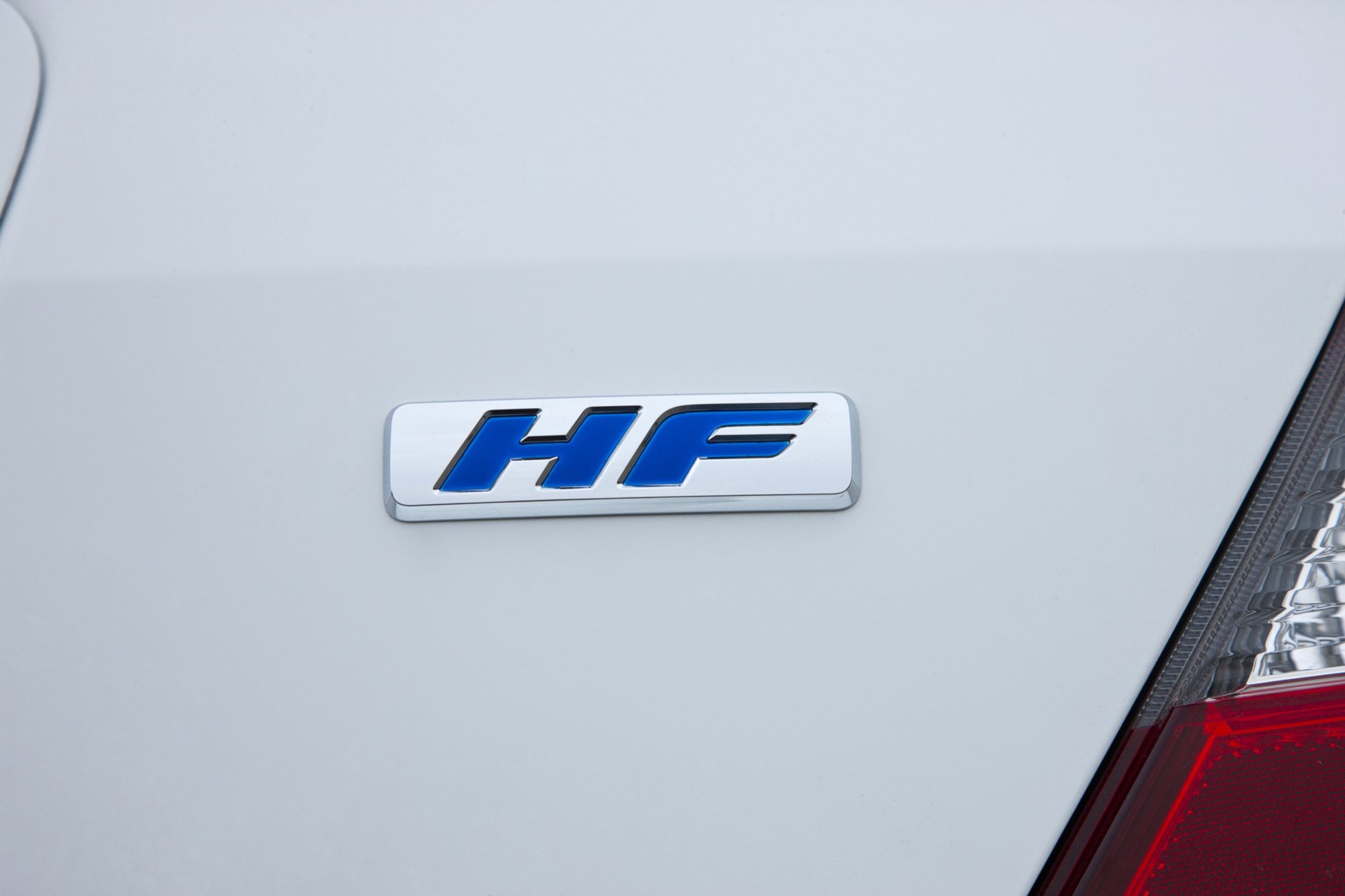 Blue HF badge on the trunk lid of a white 2012 Honda Civic HF