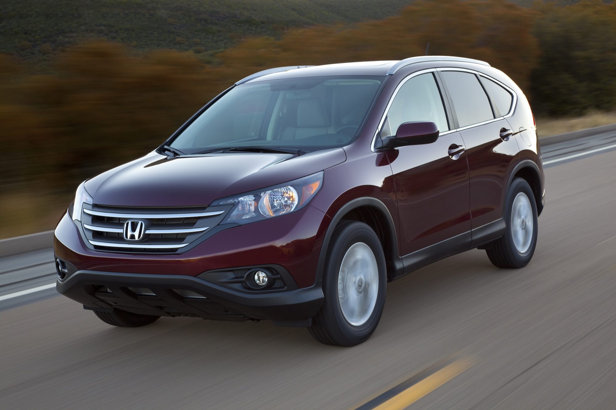 Dark red 2012 Honda CR-V EX-L AWD driving on a two-lane road