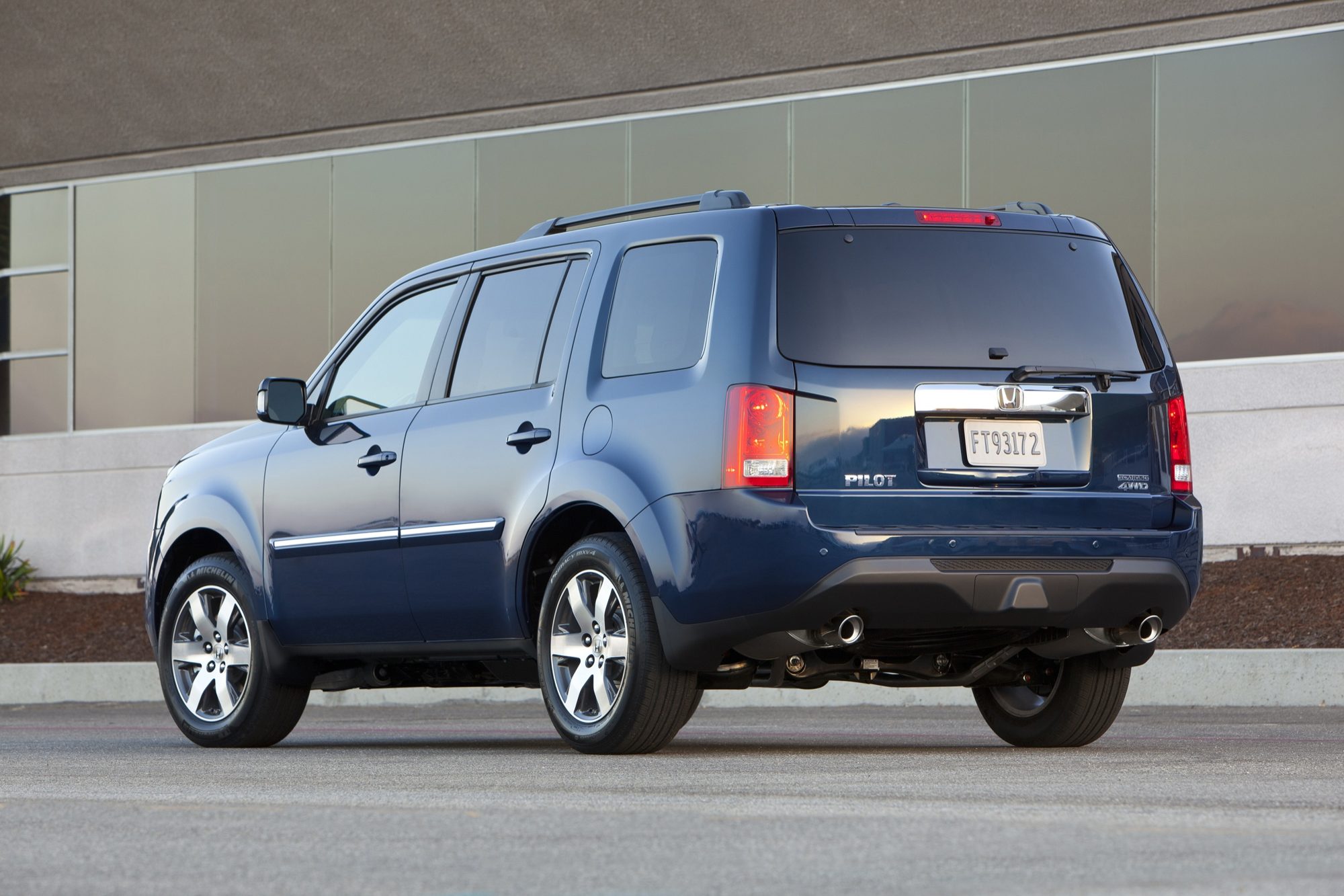 Rear three-quarter view of a dark blue 2012 Honda Pilot Touring