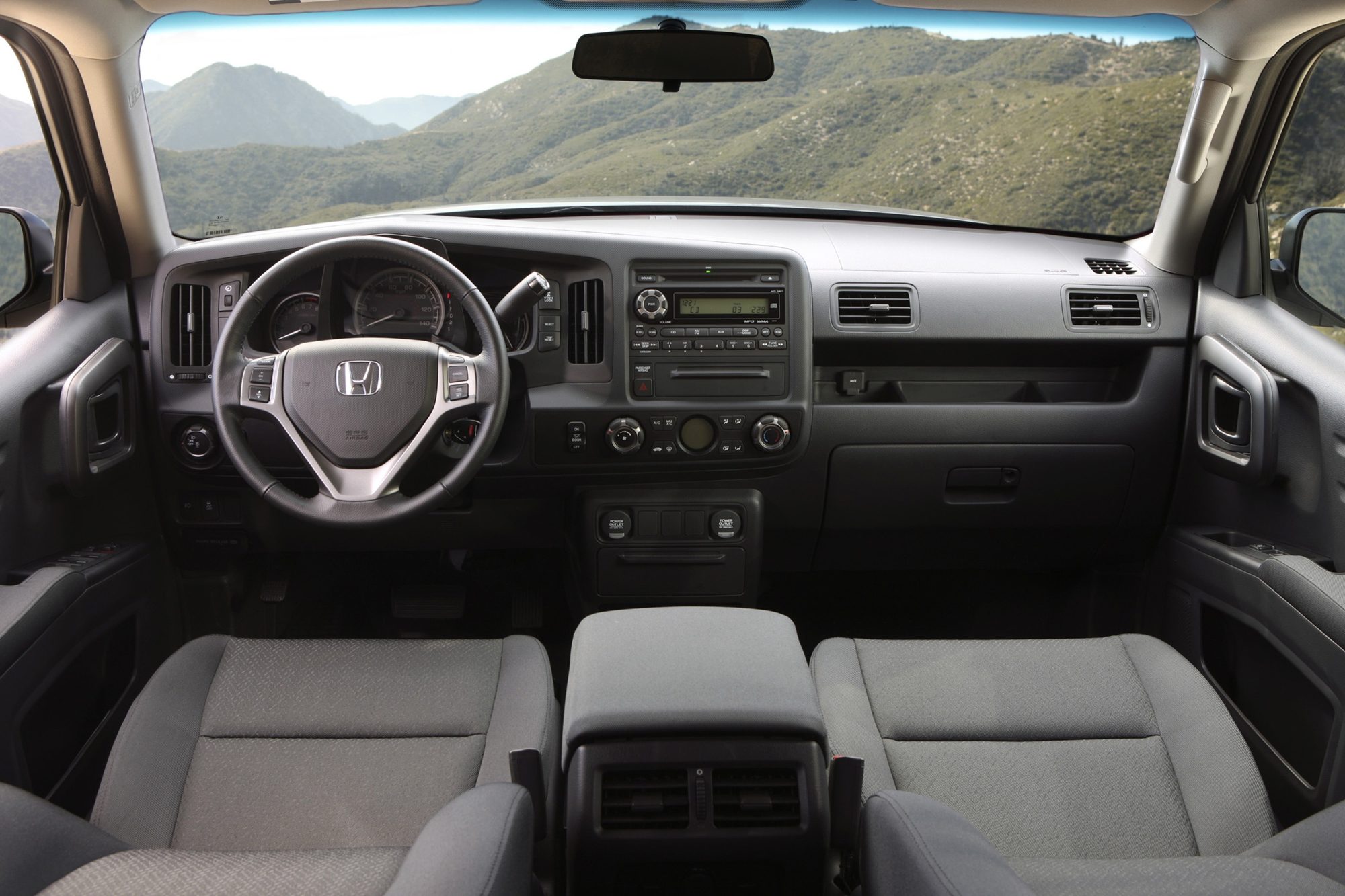Dashboard, steering wheel and gray cloth front seats of the 2012 Honda Ridgeline Sport