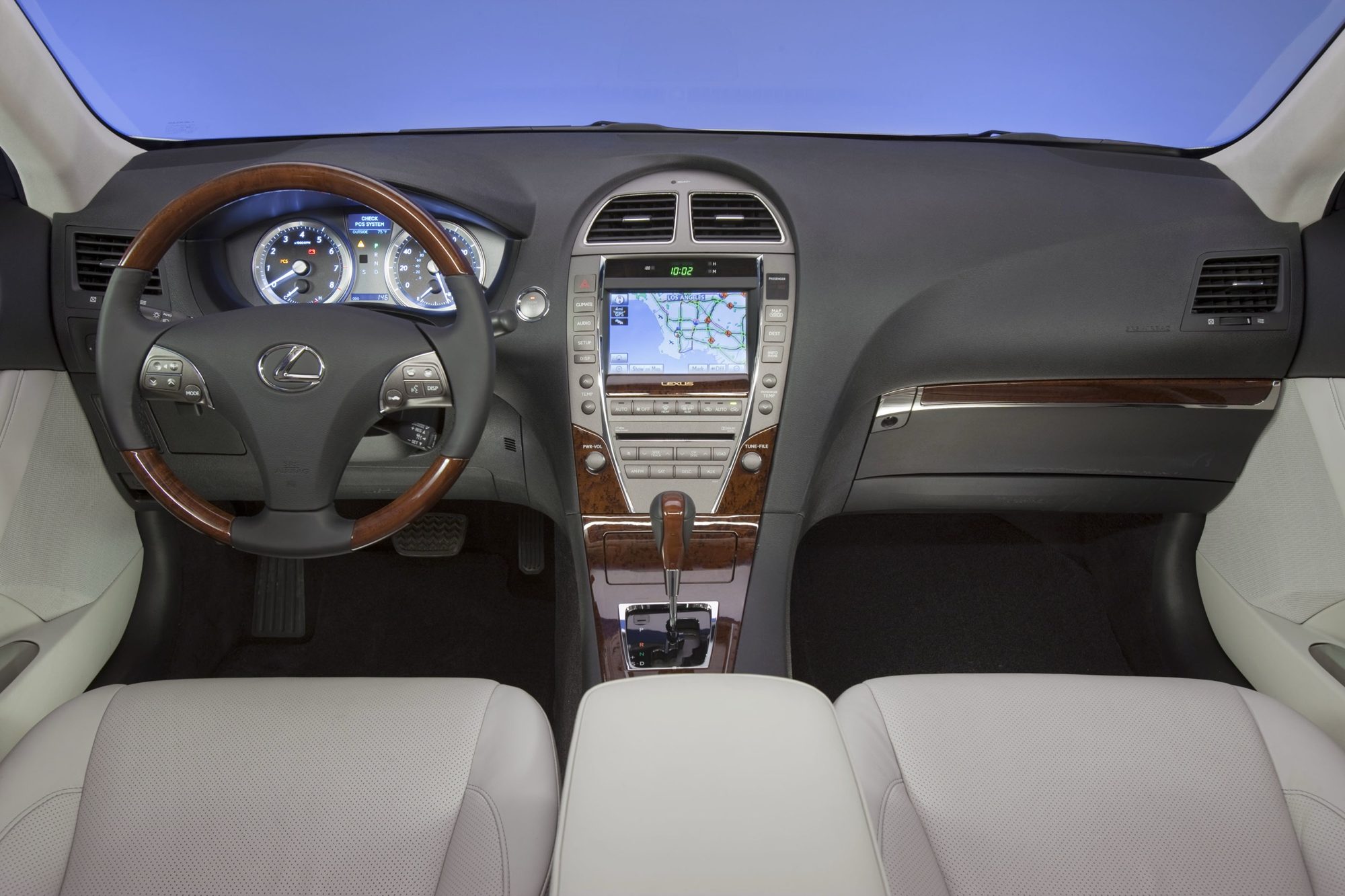 Dashboard of the 2012 Lexus ES 350 with wood trim, wood-and-leather steering wheel and navigation screen
