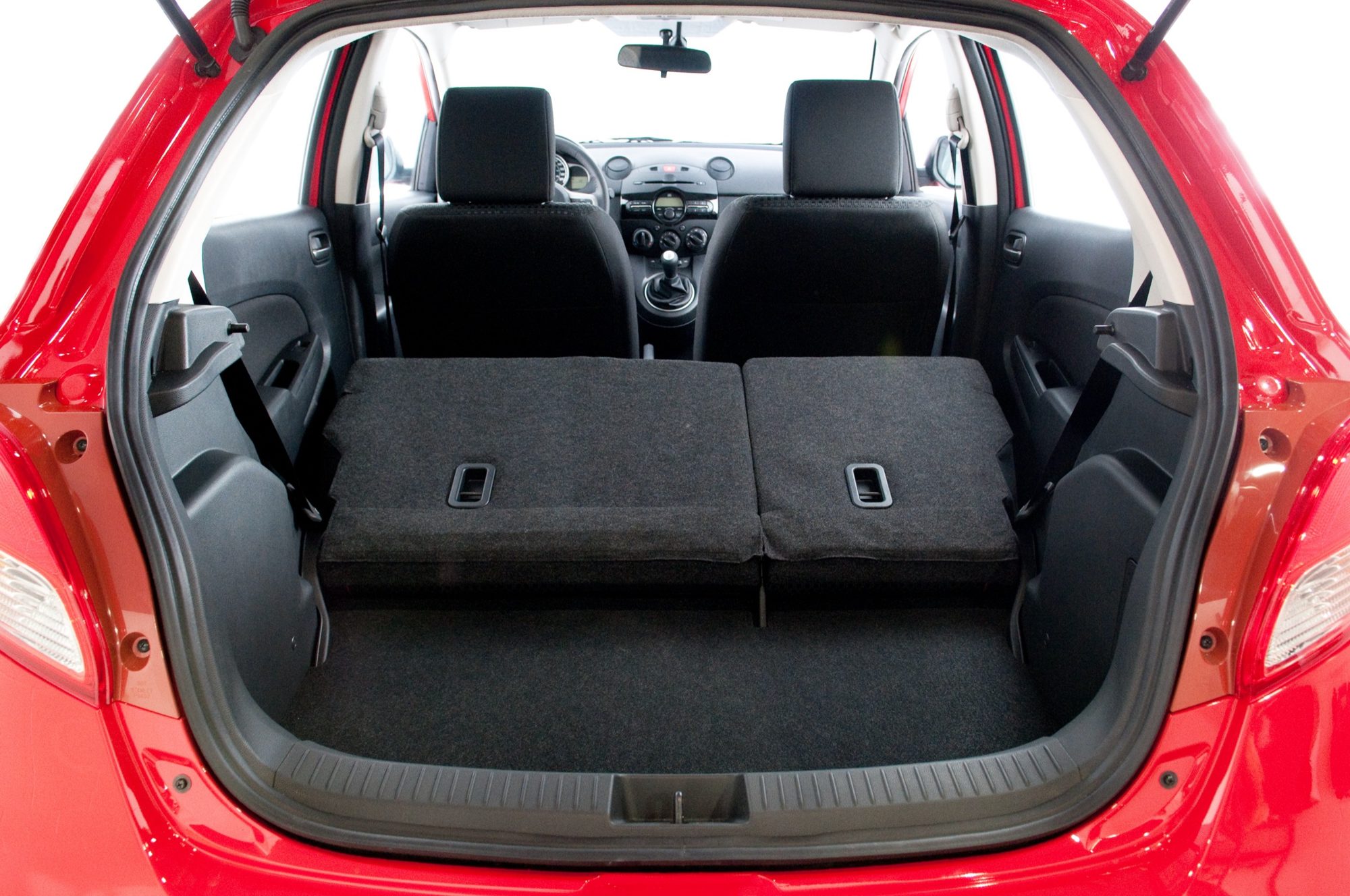 Cargo area of the 2012 Mazda2 with the rear seat folded flat