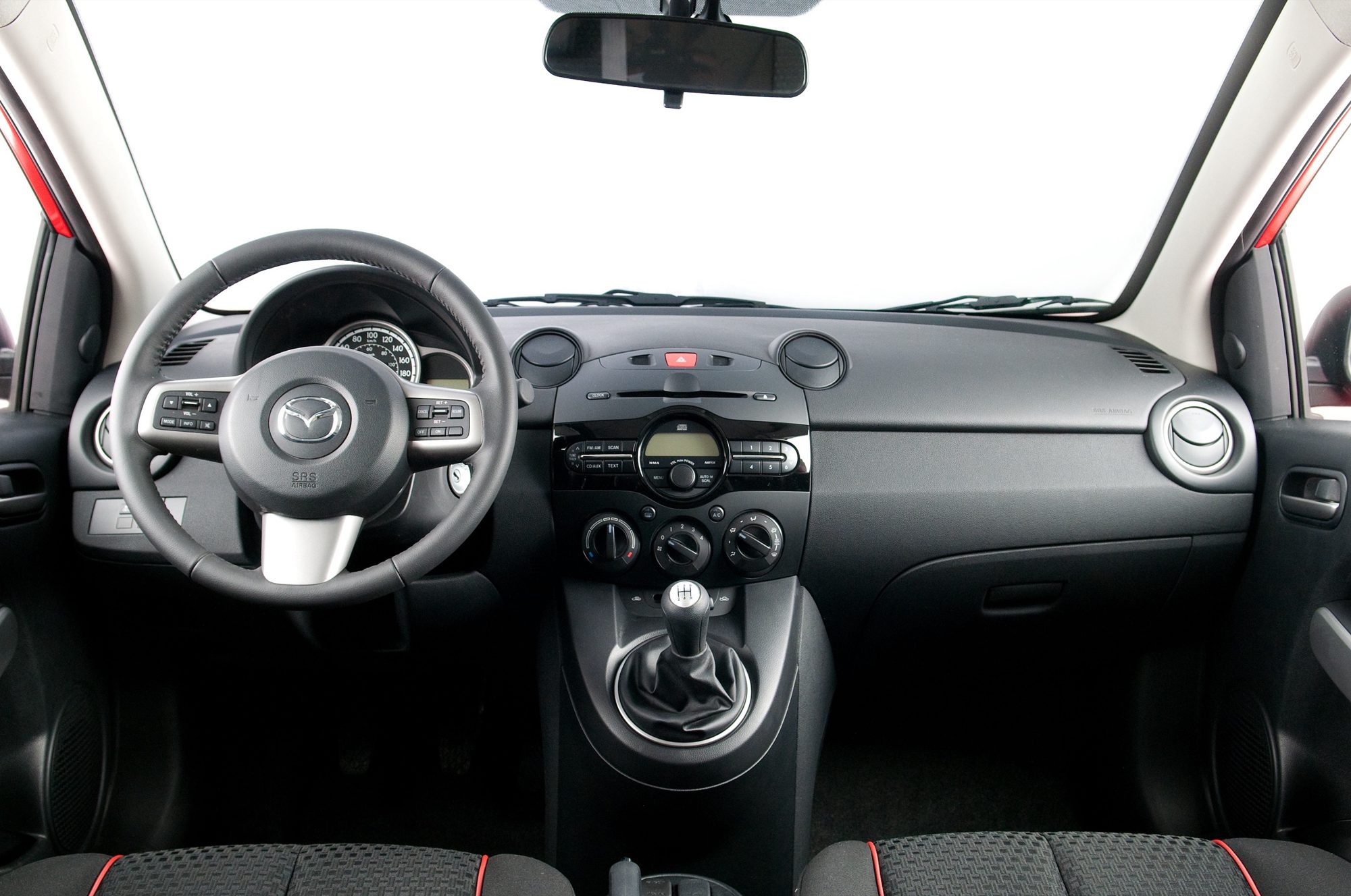 Dashboard and five-speed manual shifter of the 2012 Mazda2