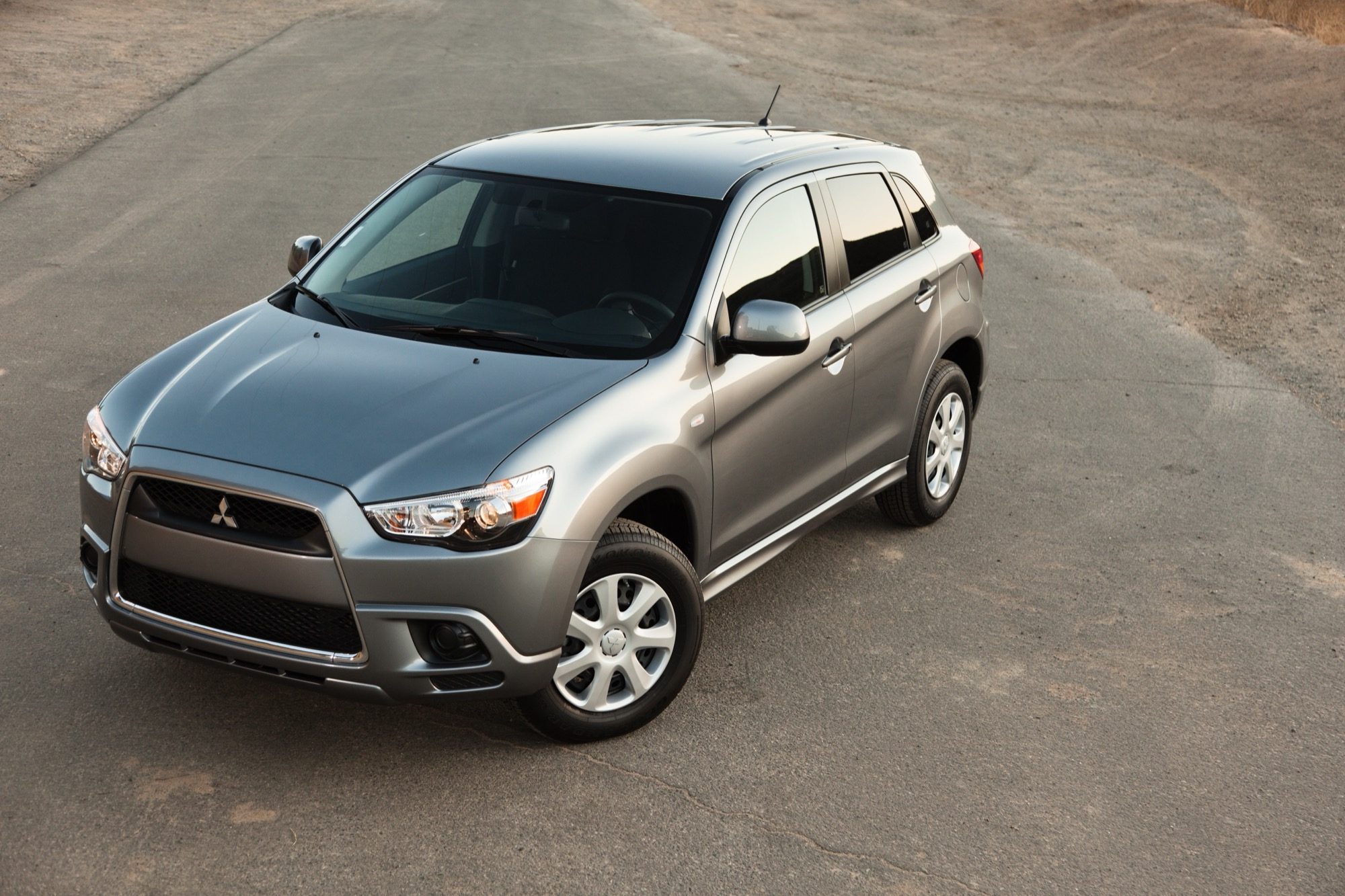 High-angle front three-quarter view of a gray 2012 Mitsubishi Outlander Sport ES