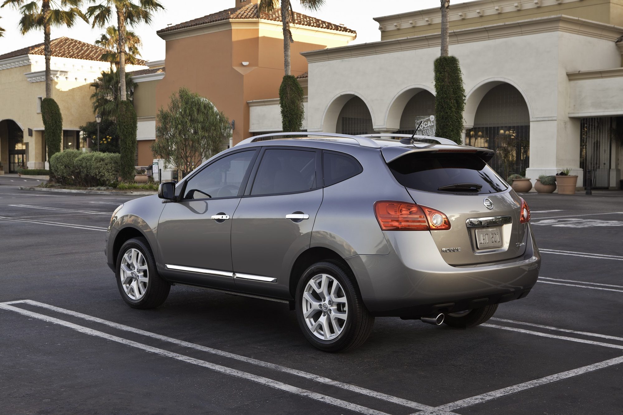 Rear three-quarter view of a gray 2012 Nissan Rogue in a parking lot