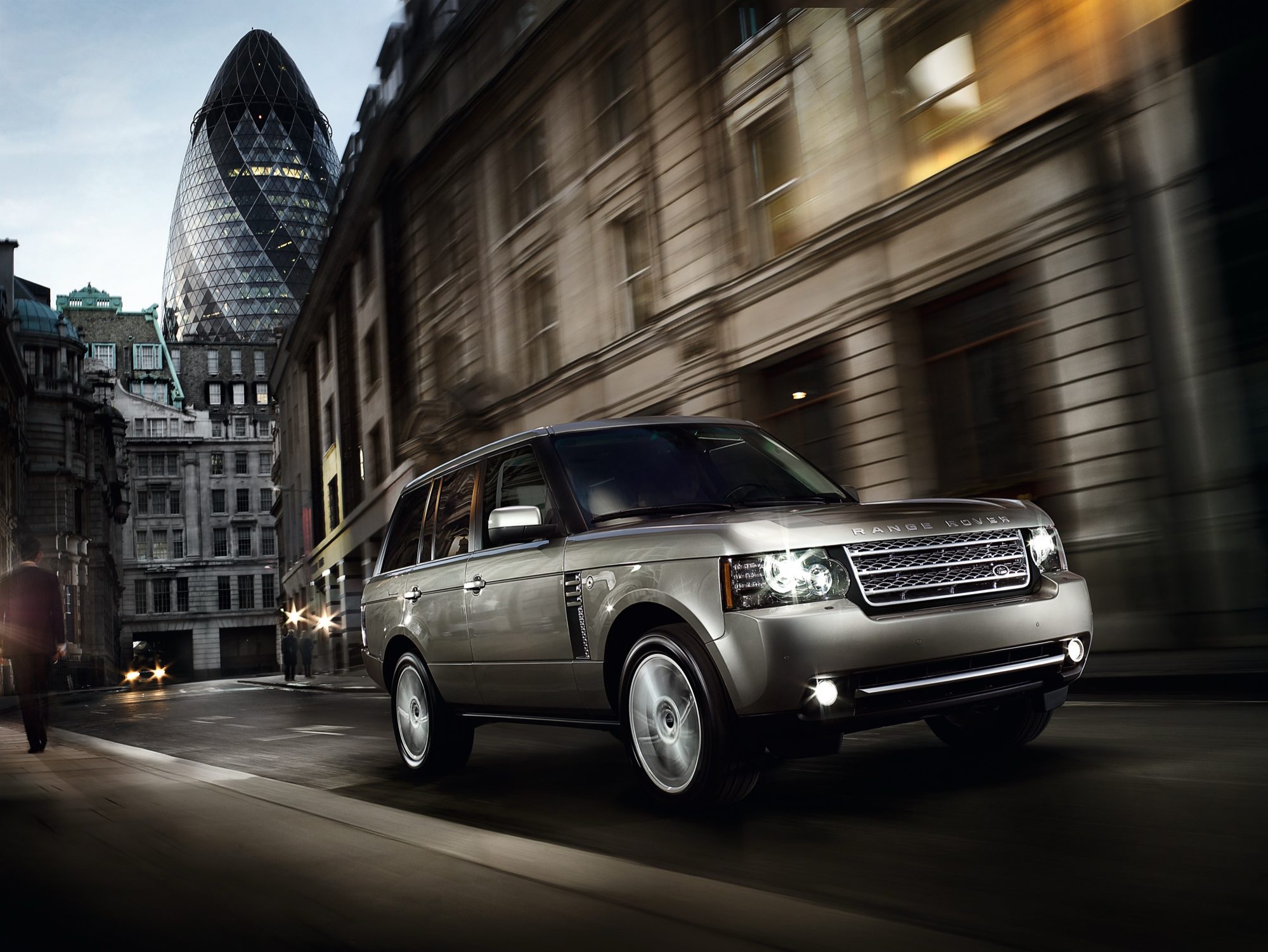 2012 Range Rover Supercharged in Ipanema Sand driving through the City of London with the Gherkin behind it
