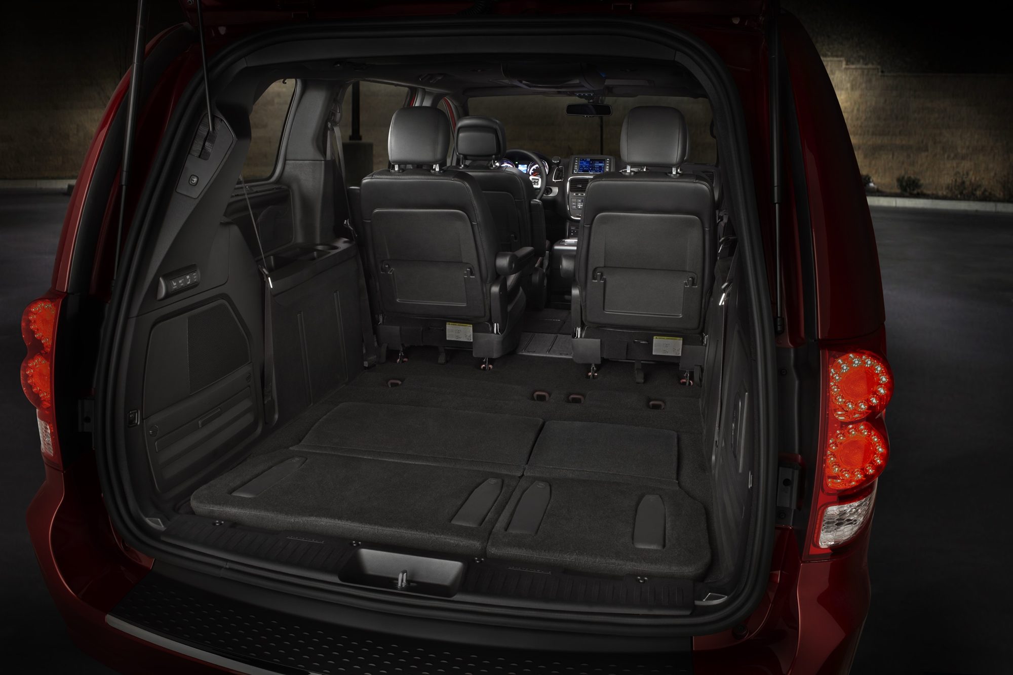 Cargo area of a 2013 Dodge Grand Caravan with the third-row seat folded into the floor