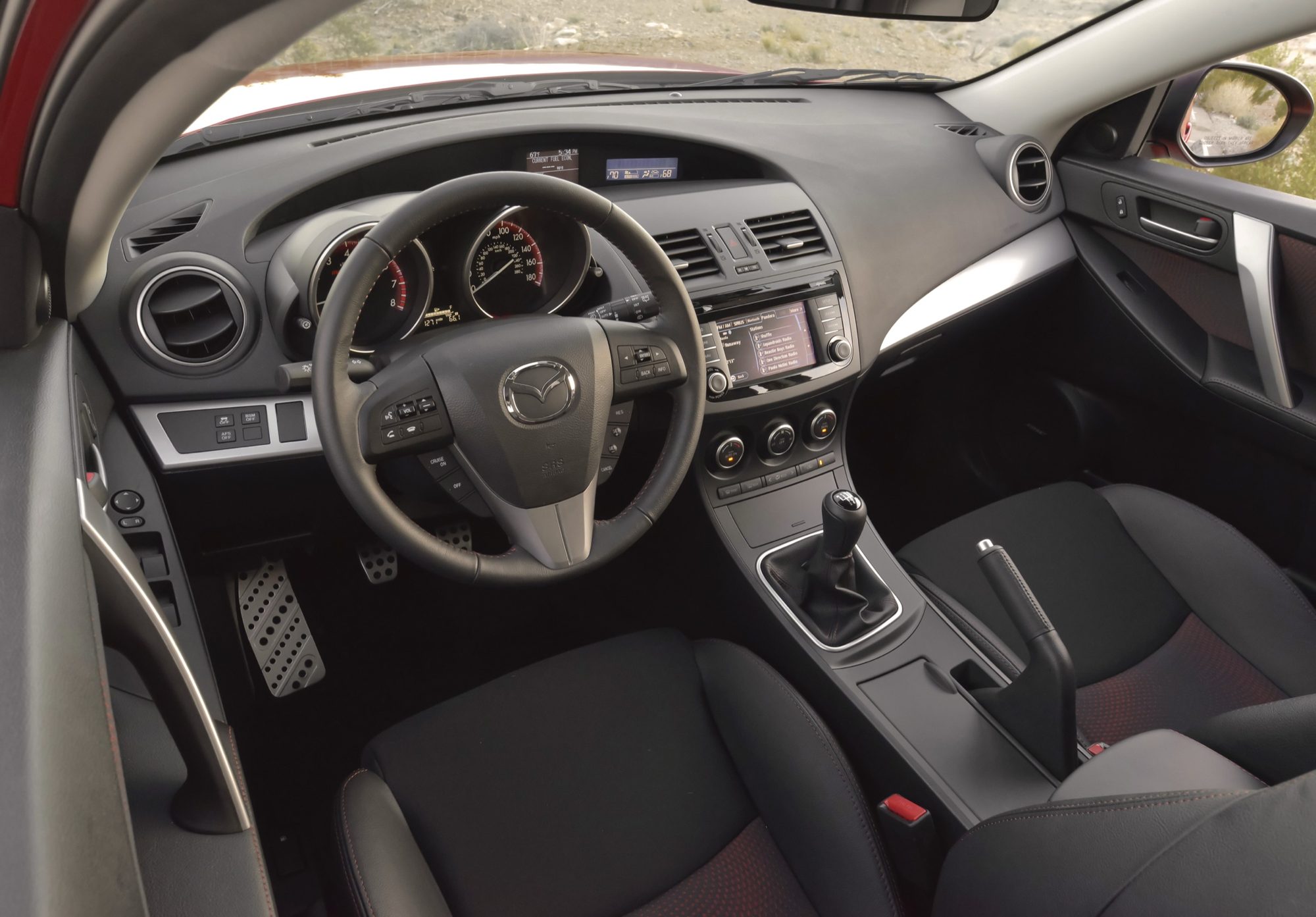 Dashboard, six-speed shifter and red-stitched sport seats of the 2013 Mazdaspeed3