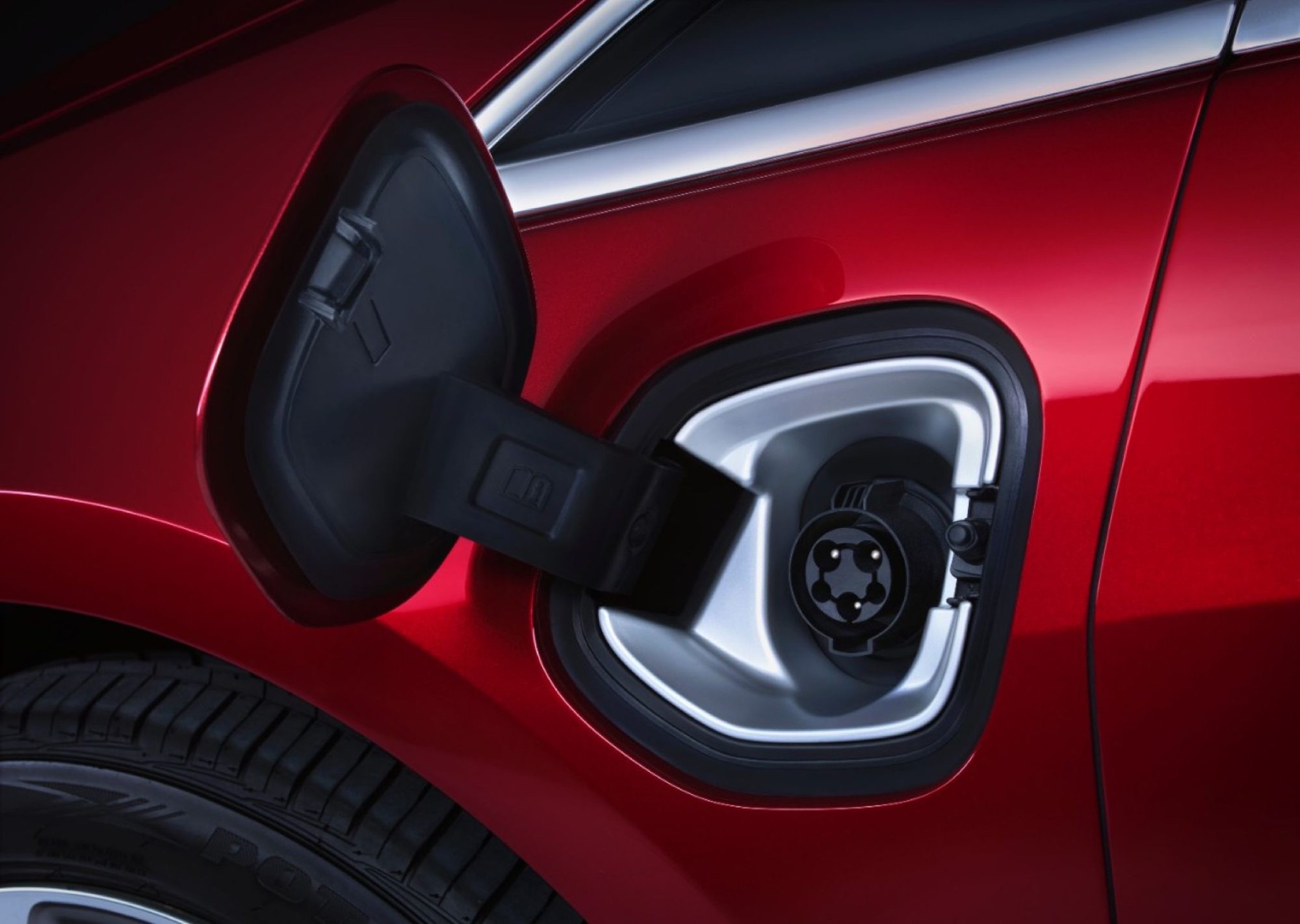 Open charge port door on the front fender of a red 2014 Cadillac ELR