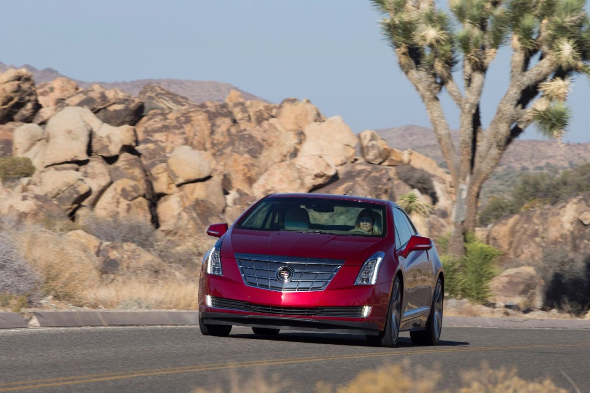 Red 2014 Cadillac ELR driving on a desert road