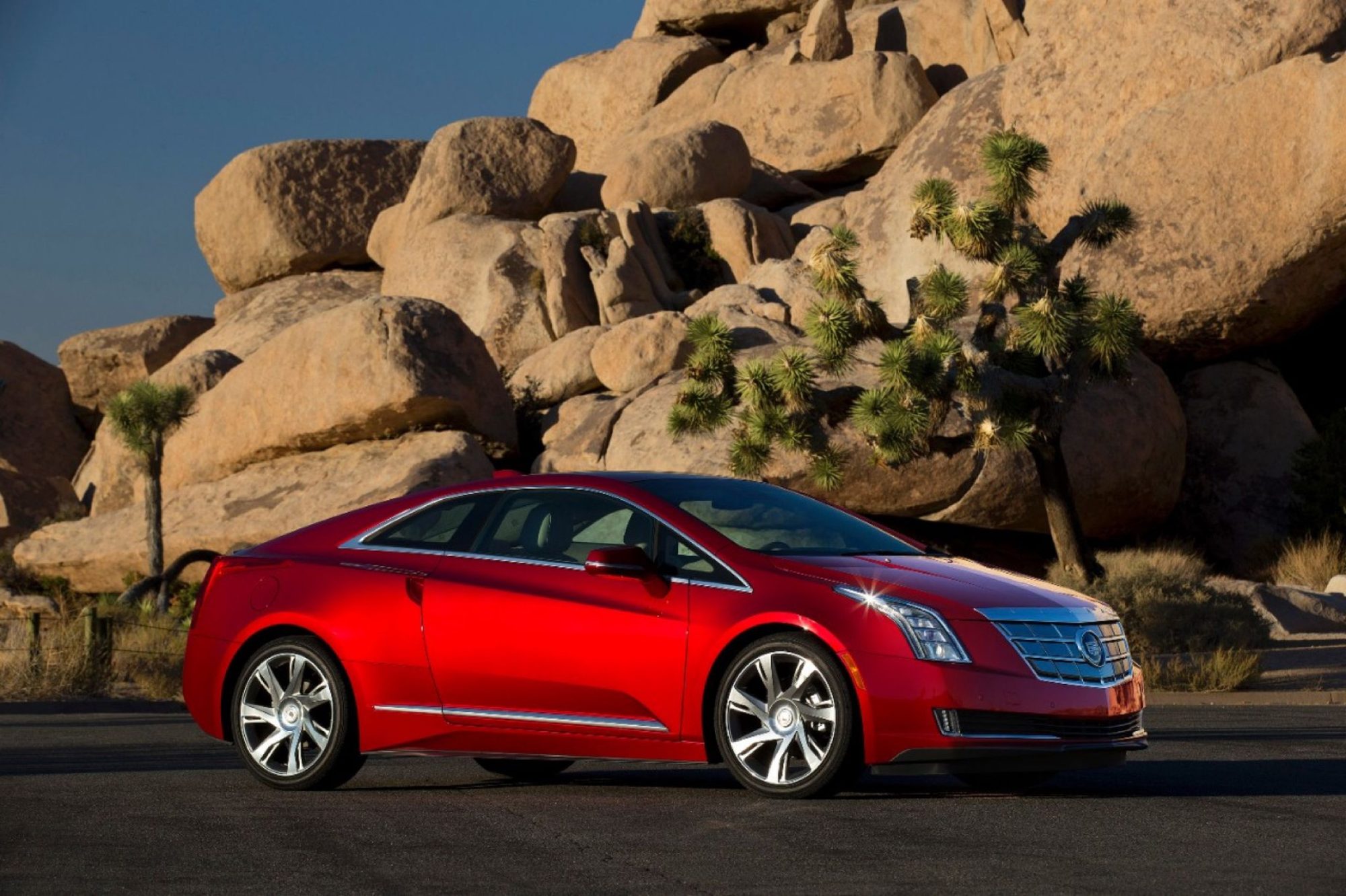 Red 2014 Cadillac ELR coupe parked among boulders in Joshua Tree