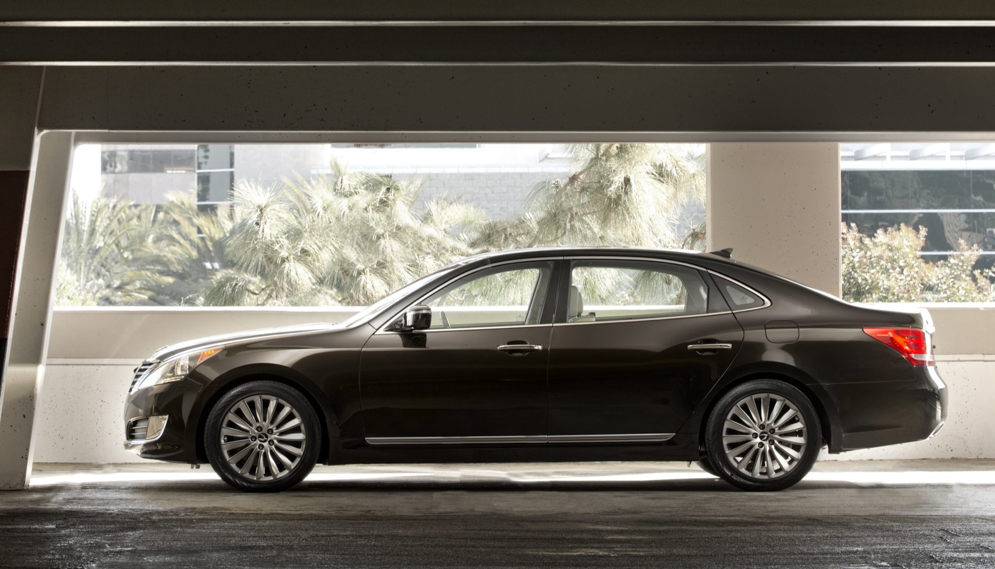 Side profile of a black 2014 Hyundai Equus in a parking structure