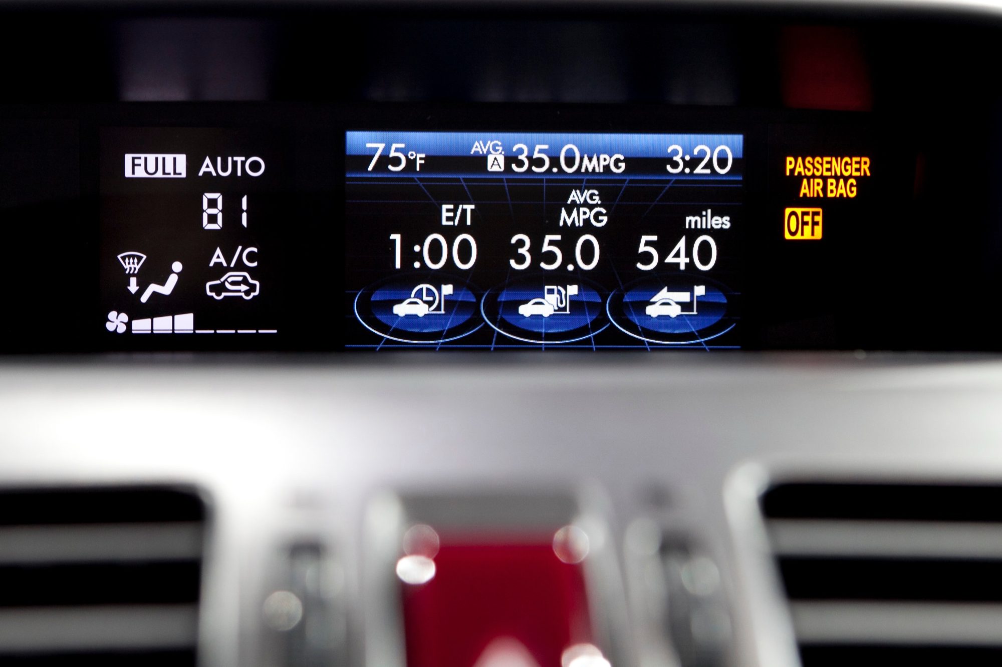 Dash-top multifunction display of the 2014 Subaru XV Crosstrek Hybrid showing average mpg and hybrid energy-flow icons