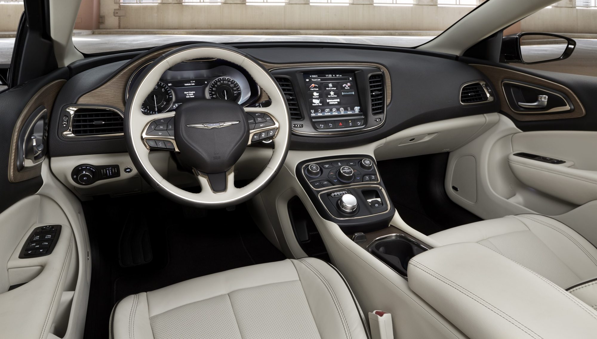 Dashboard, steering wheel and touchscreen of the 2015 Chrysler 200C with light leather seats