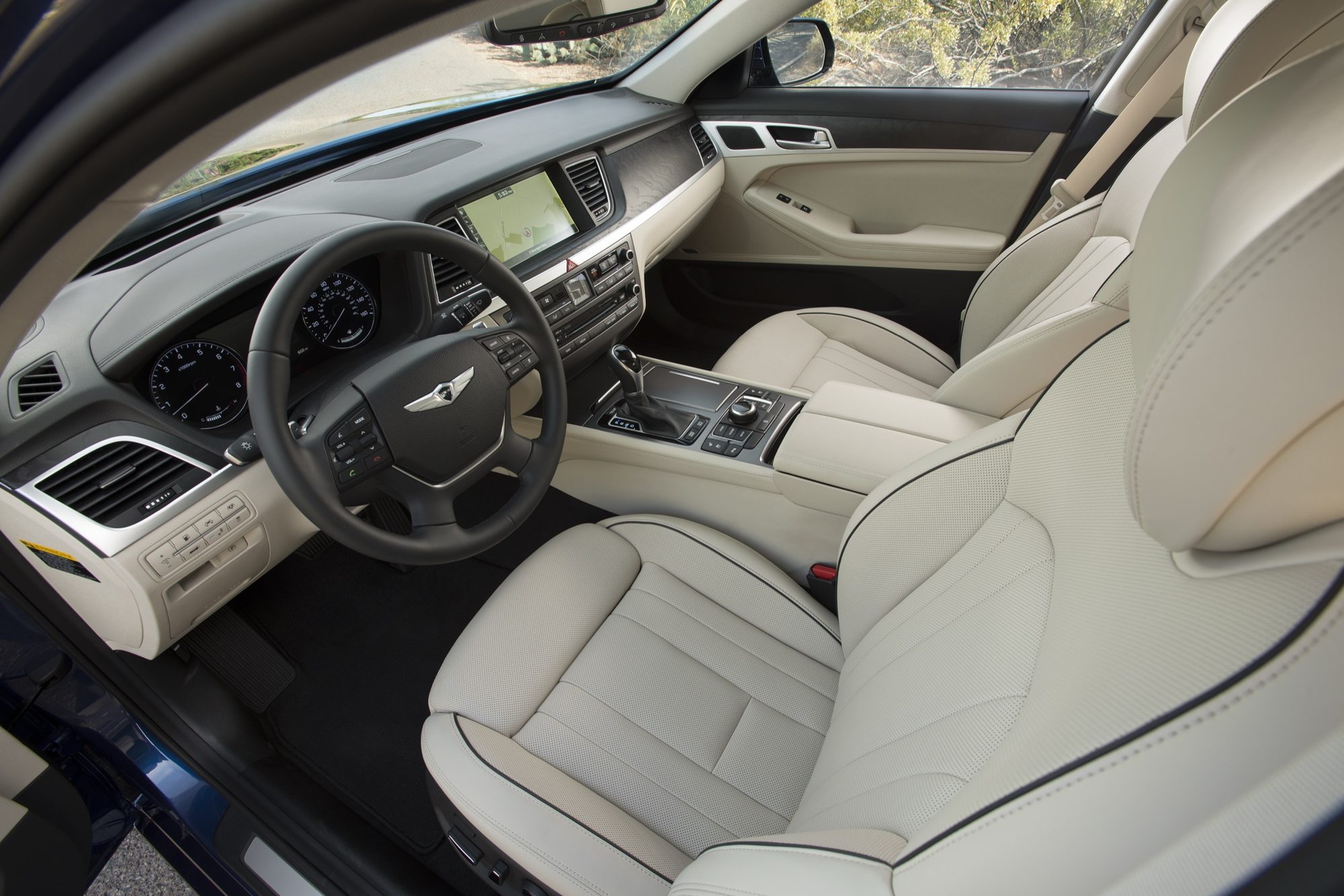 Dashboard and ivory leather front seats of the 2015 Hyundai Genesis with wood and aluminum trim
