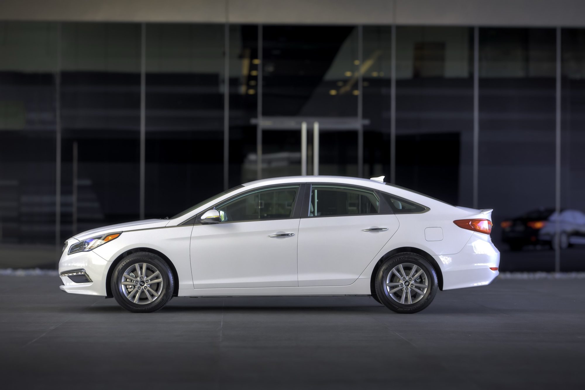 Side profile of a white 2015 Hyundai Sonata Eco showing the sloping roofline