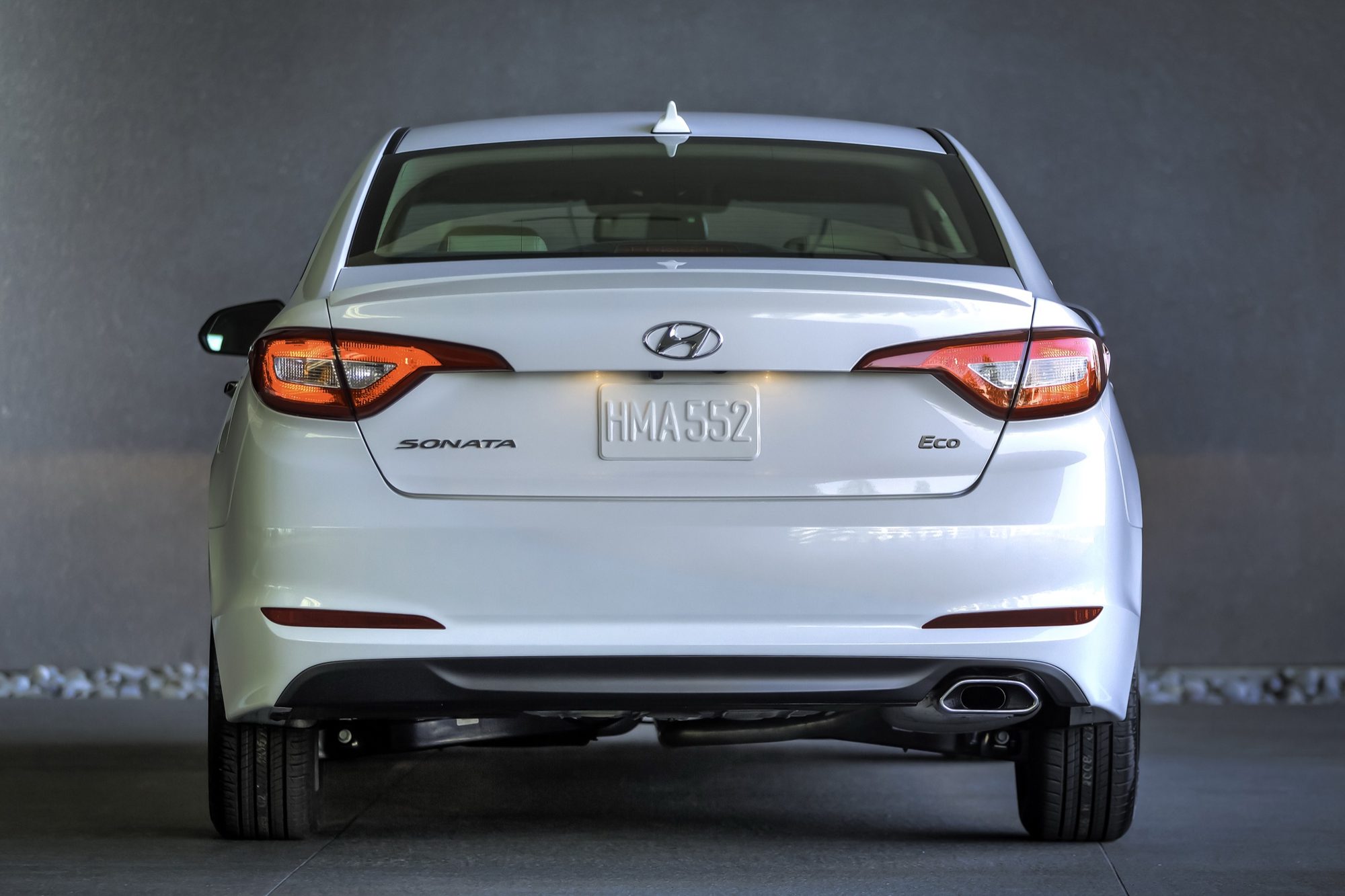 Rear view of a white 2015 Hyundai Sonata Eco with the Eco badge on the trunk lid
