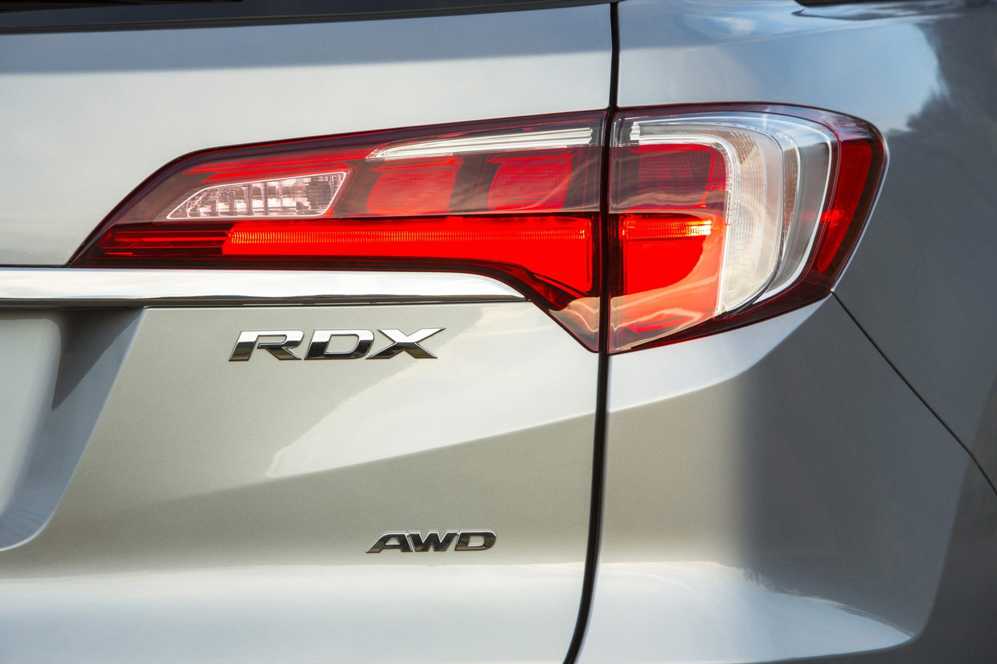 RDX and AWD badges and taillight on a silver 2016 Acura RDX
