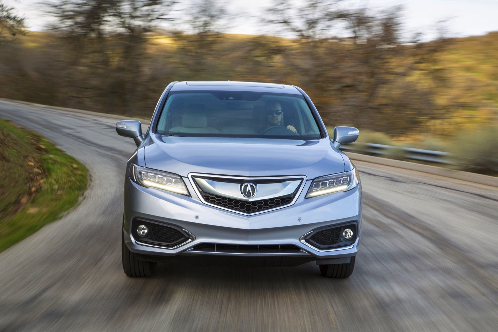 Silver 2016 Acura RDX driving through a curve