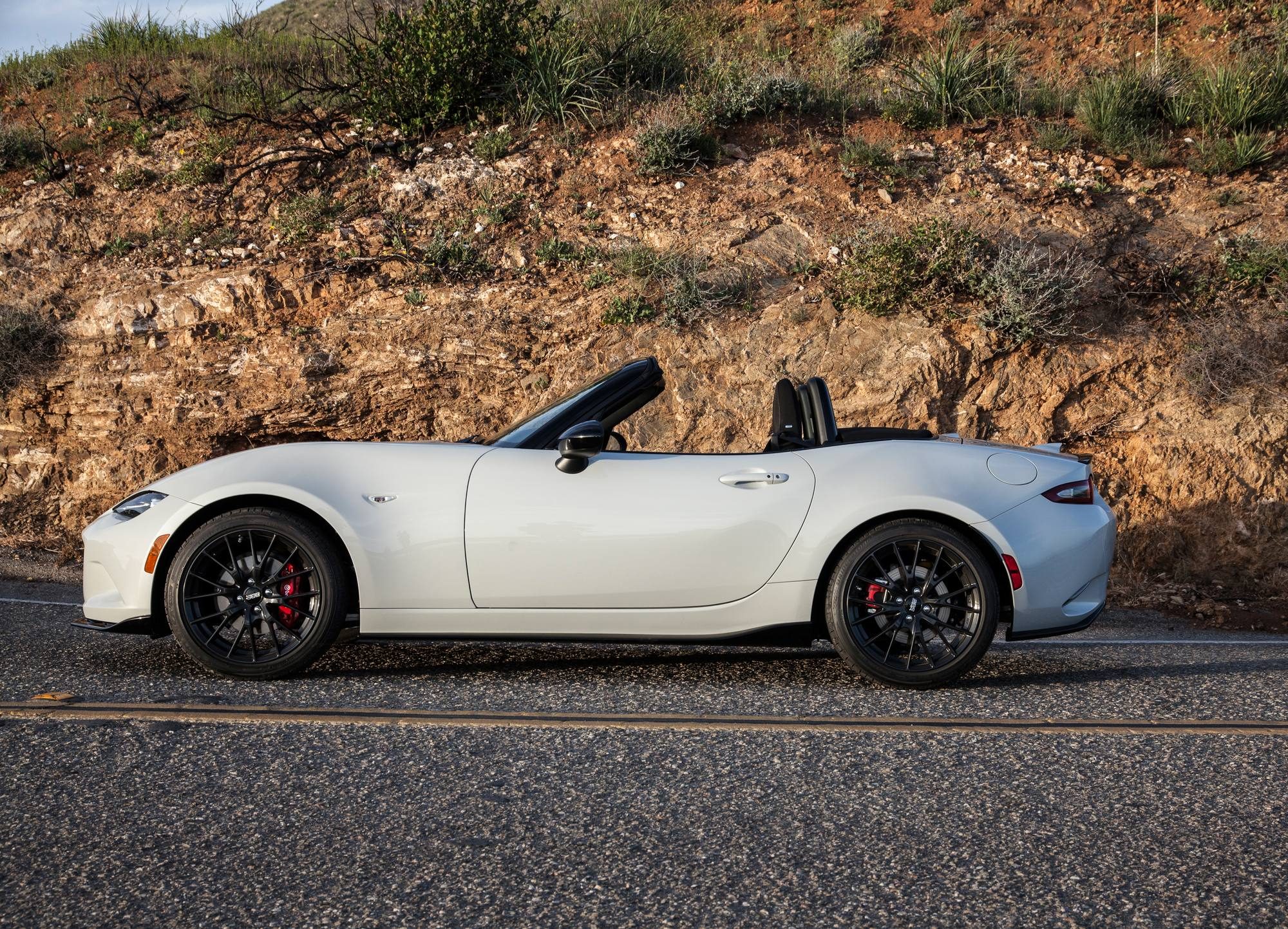 2016 Mazda MX-5 Miata: Lighter, faster, more fun 2 White 2016 Mazda MX-5 Miata Club with its top down, parked beside a rocky hillside
