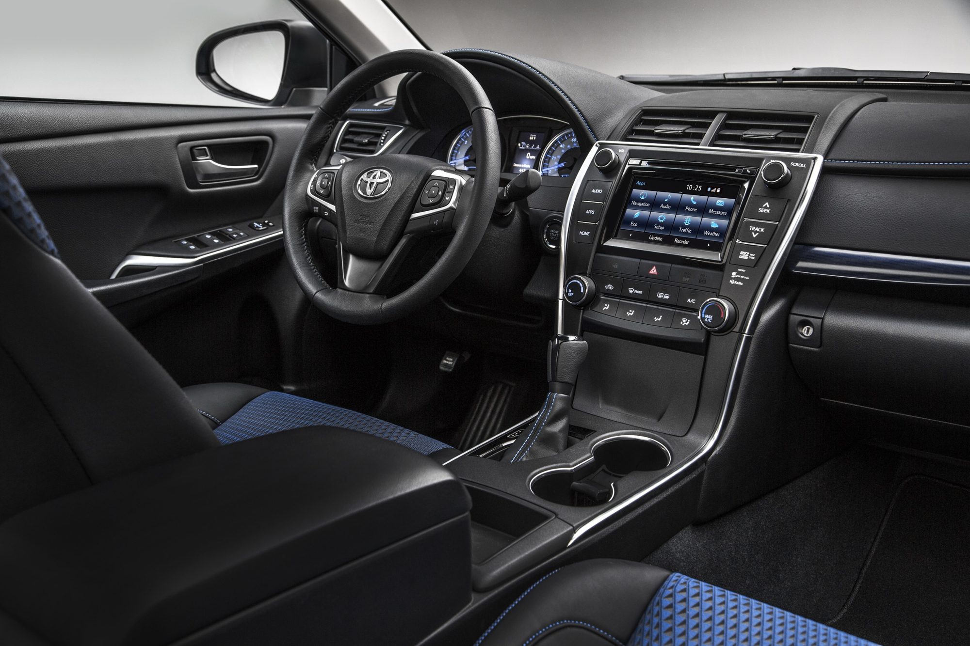 Interior of the 2016 Toyota Camry Special Edition with blue-stitched black seats and touchscreen