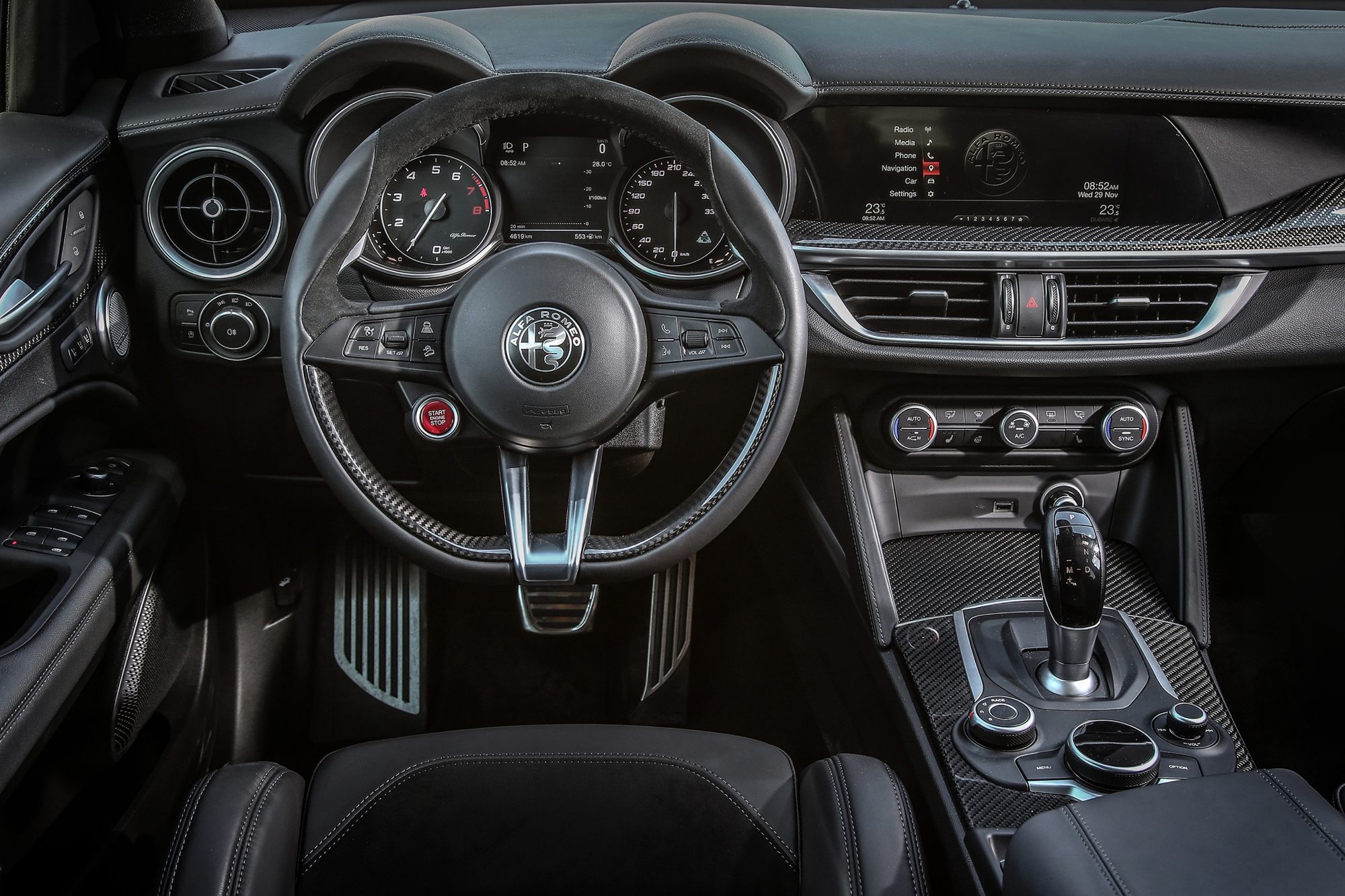 Carbon fiber steering wheel with start button, paddle shifters and electronic shifter in the 2018 Alfa Romeo Stelvio Quadrifoglio