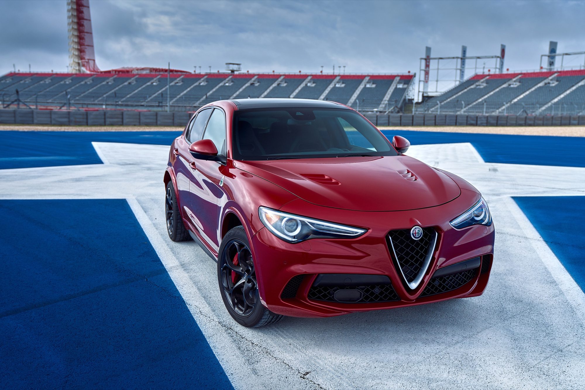 Front three-quarter view of the 2018 Alfa Romeo Stelvio Quadrifoglio in Rosso Competizione at Circuit of the Americas