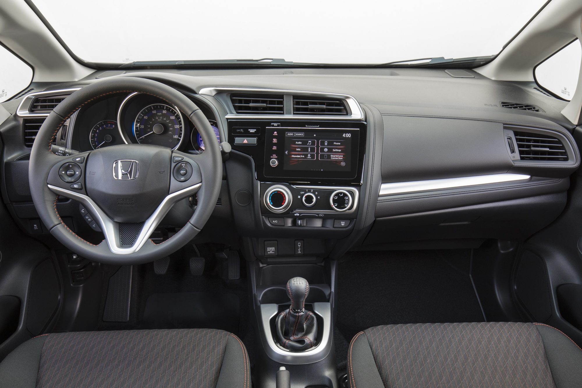 Dashboard of the 2018 Honda Fit Sport with the 7-inch touchscreen and six-speed manual shifter