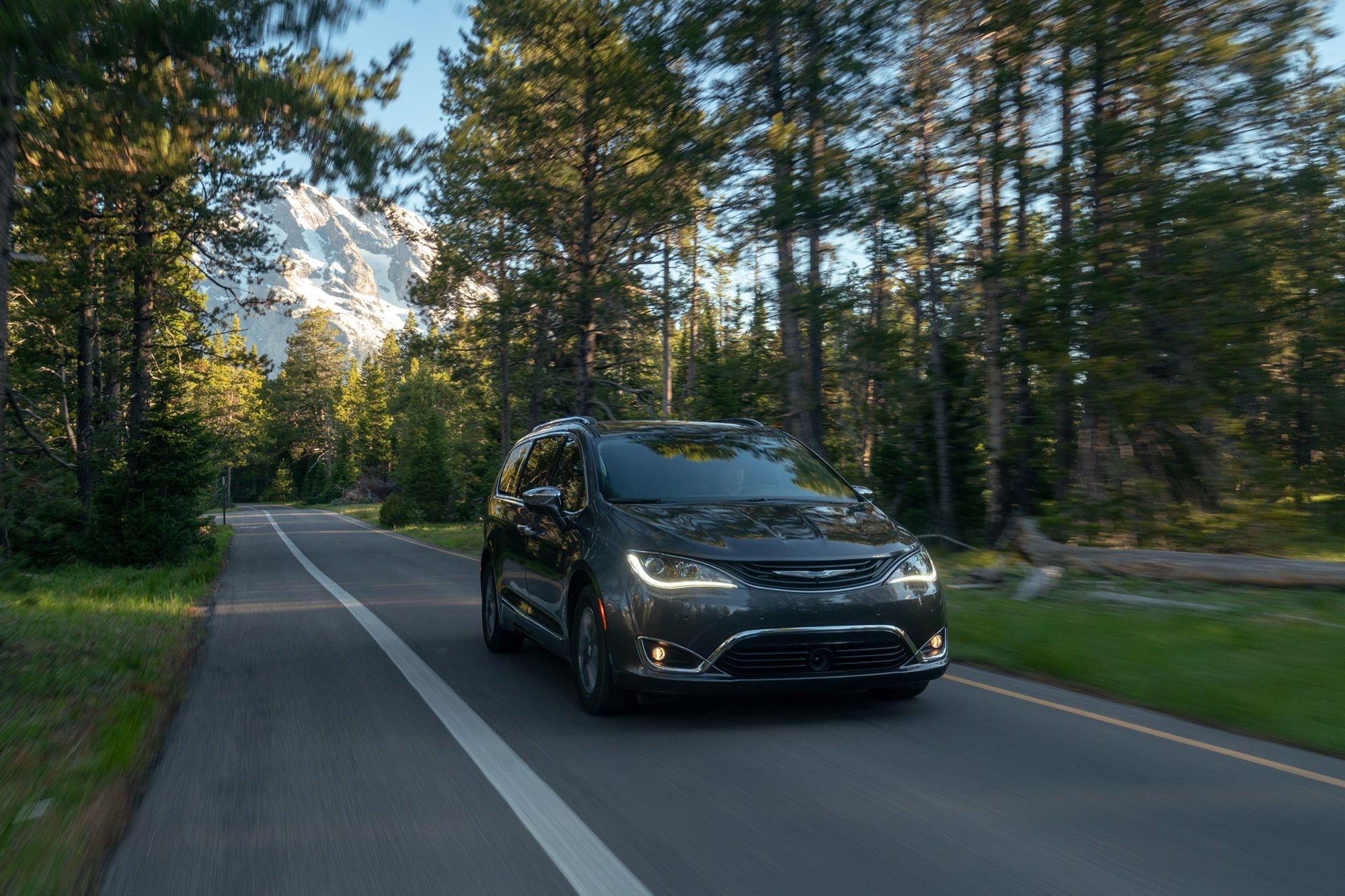 Gray 2019 Chrysler Pacifica Hybrid Limited driving on a forest road