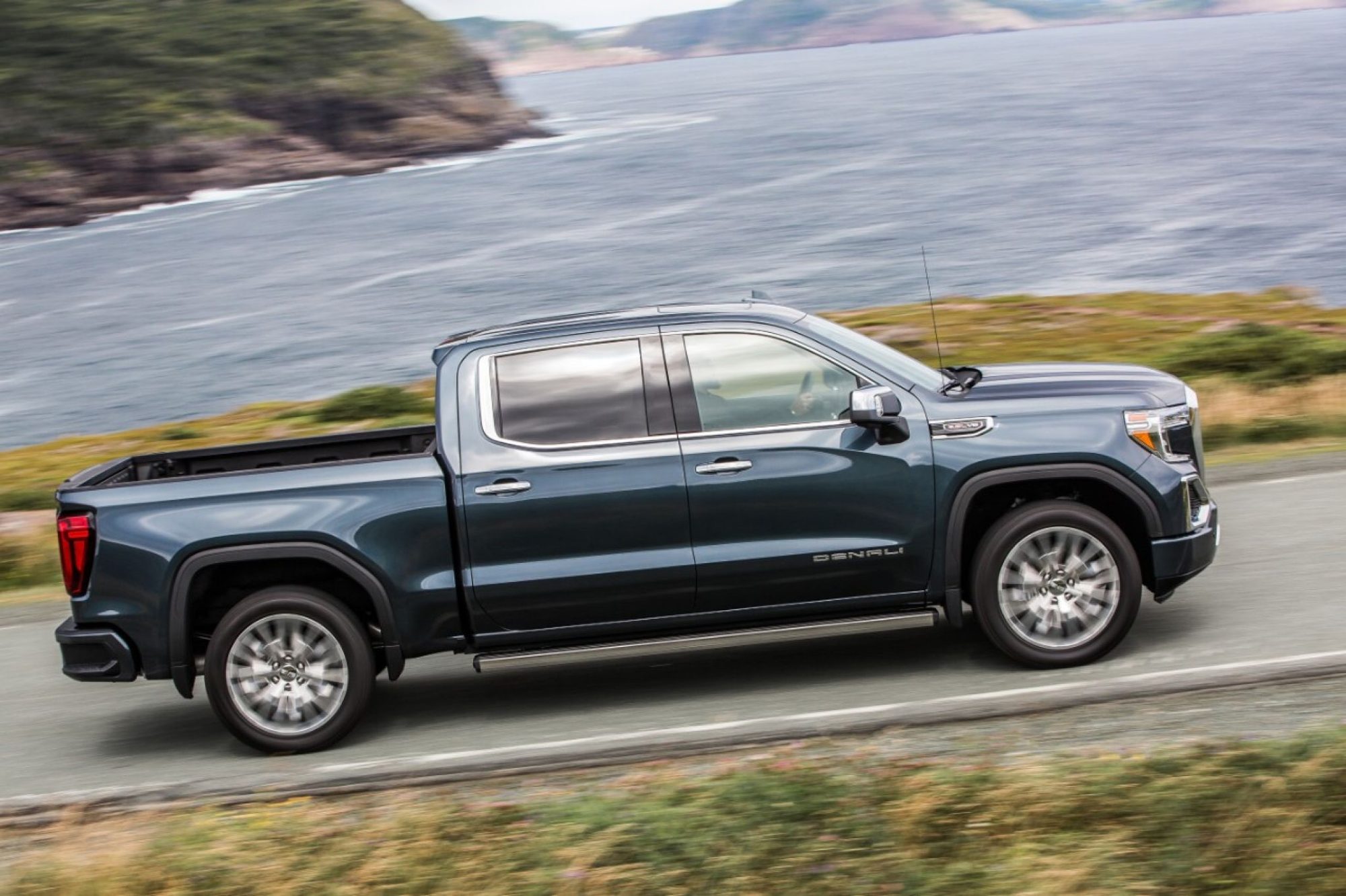 2019 GMC Sierra 1500 Denali crew cab driving along a coastal road