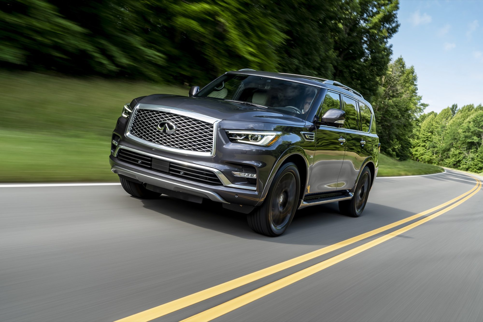 Gray 2019 Infiniti QX80 Limited driving on a two-lane road