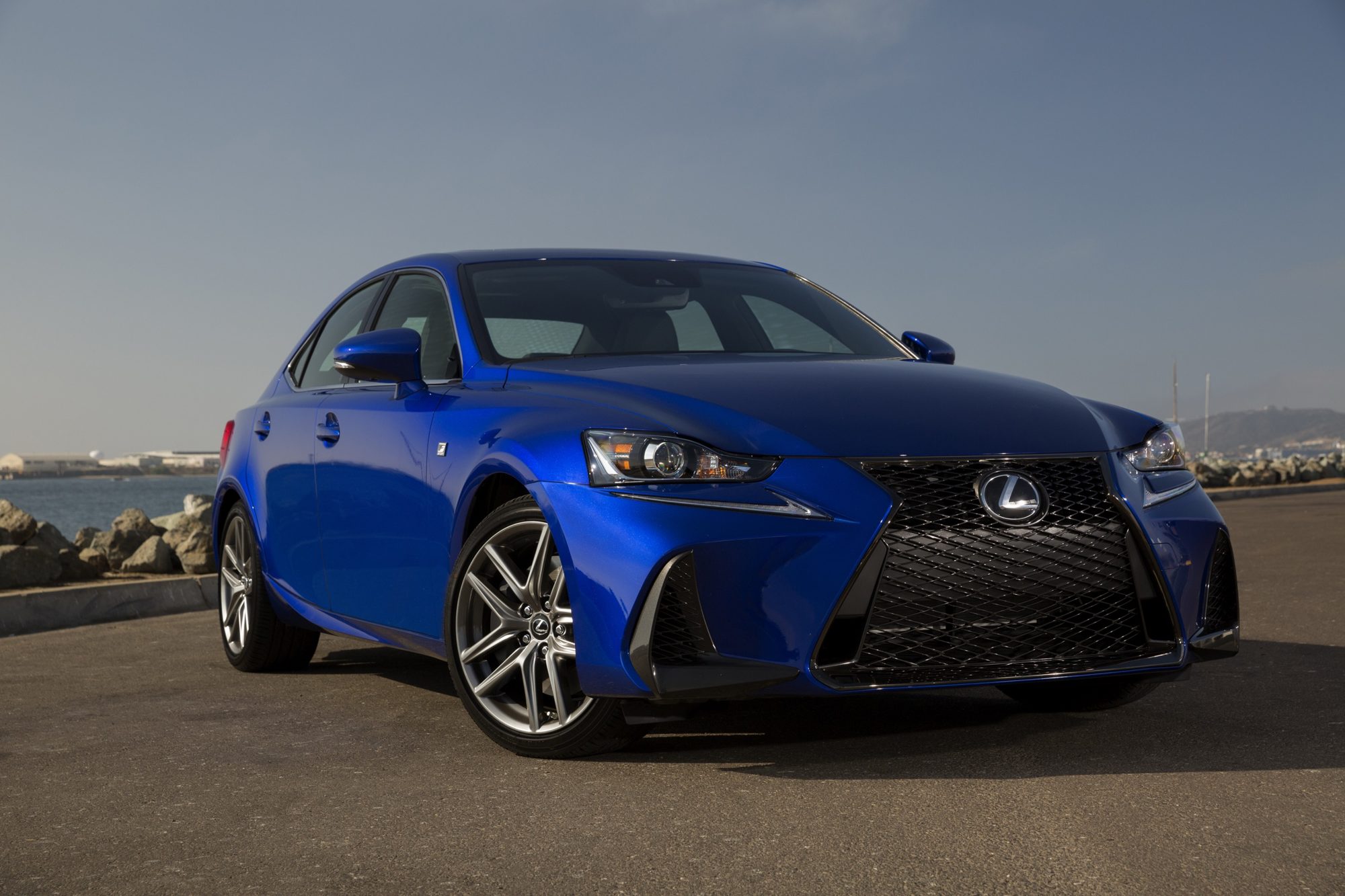 Blue 2019 Lexus IS 350 F Sport sedan, front three-quarter view by a harbor