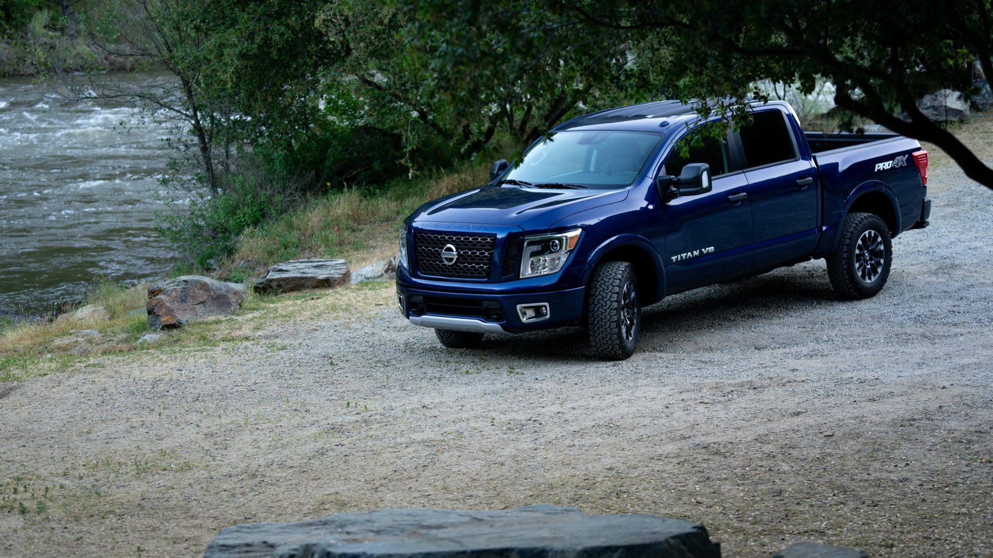 2019 Nissan Titan Review: Tough competitors, tough road ahead 5 Blue 2019 Nissan Titan PRO-4X parked on gravel beside a river