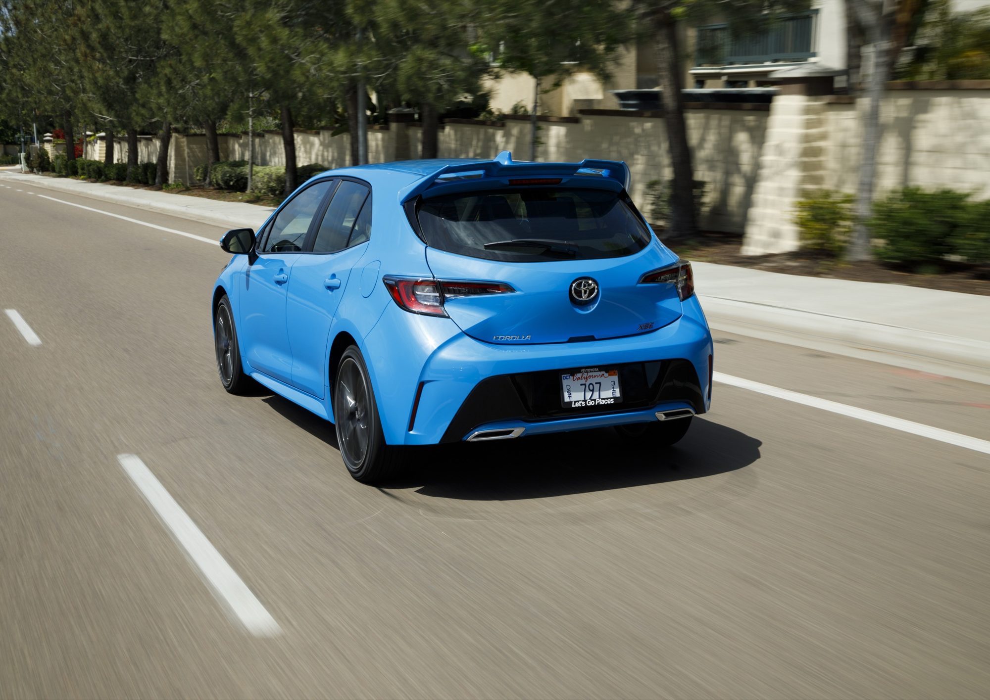 Rear view of the 2019 Toyota Corolla Hatchback XSE in Blue Flame on the road