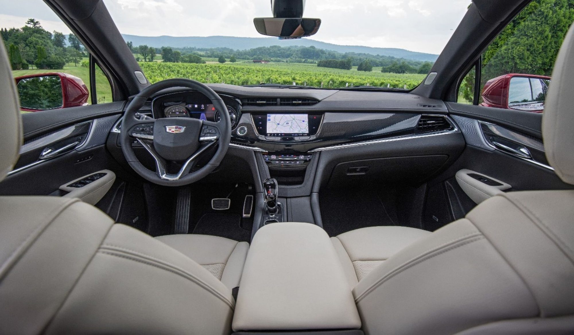 Dashboard and front seats of the 2020 Cadillac XT6 Sport seen from the rear seat