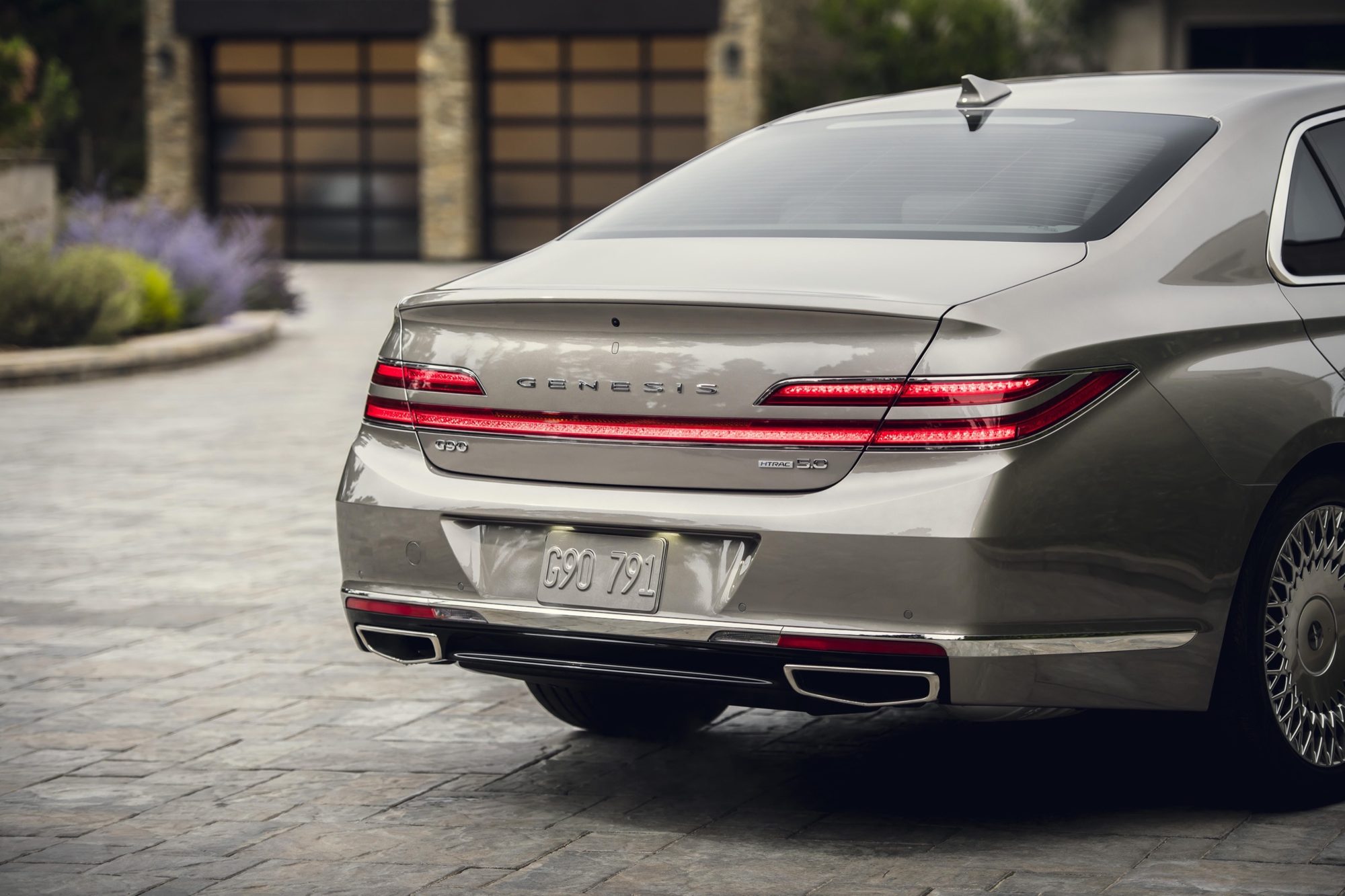 Rear three-quarter view of a 2020 Genesis G90 in Gold Coast Silver