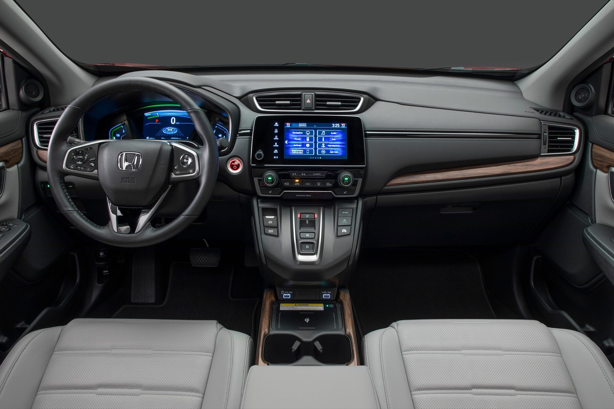 Dashboard of the 2020 Honda CR-V Hybrid with wood-look trim and light gray leather seats