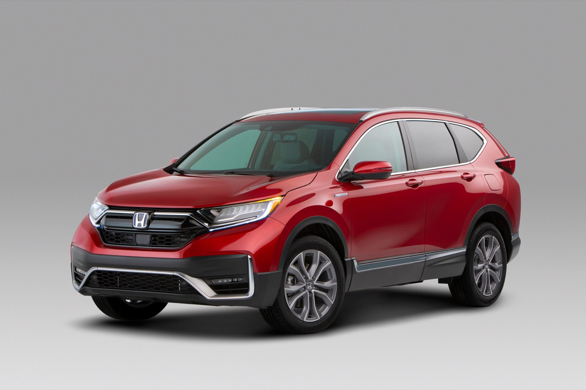 Front three-quarter view of a red 2020 Honda CR-V Hybrid Touring