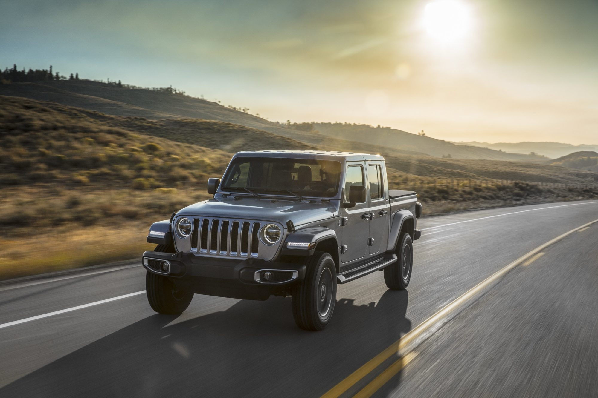 Silver 2020 Jeep Gladiator Overland driving on a two-lane highway