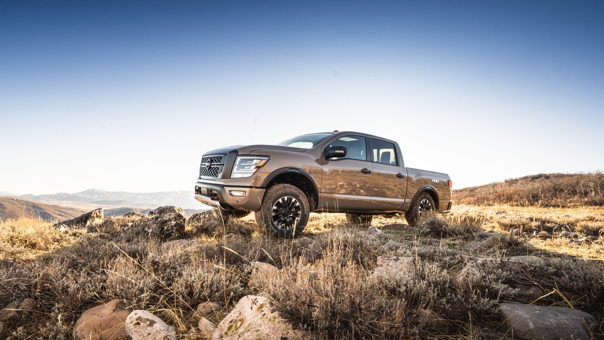 Tan 2020 Nissan Titan PRO-4X crew cab parked on a rocky hillside
