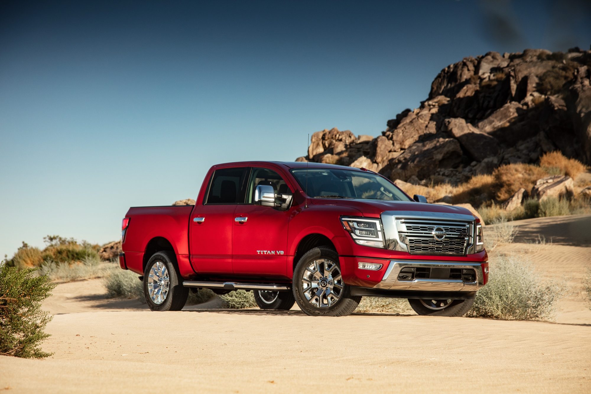 Front three-quarter view of a red 2020 Nissan Titan SL crew cab in the desert